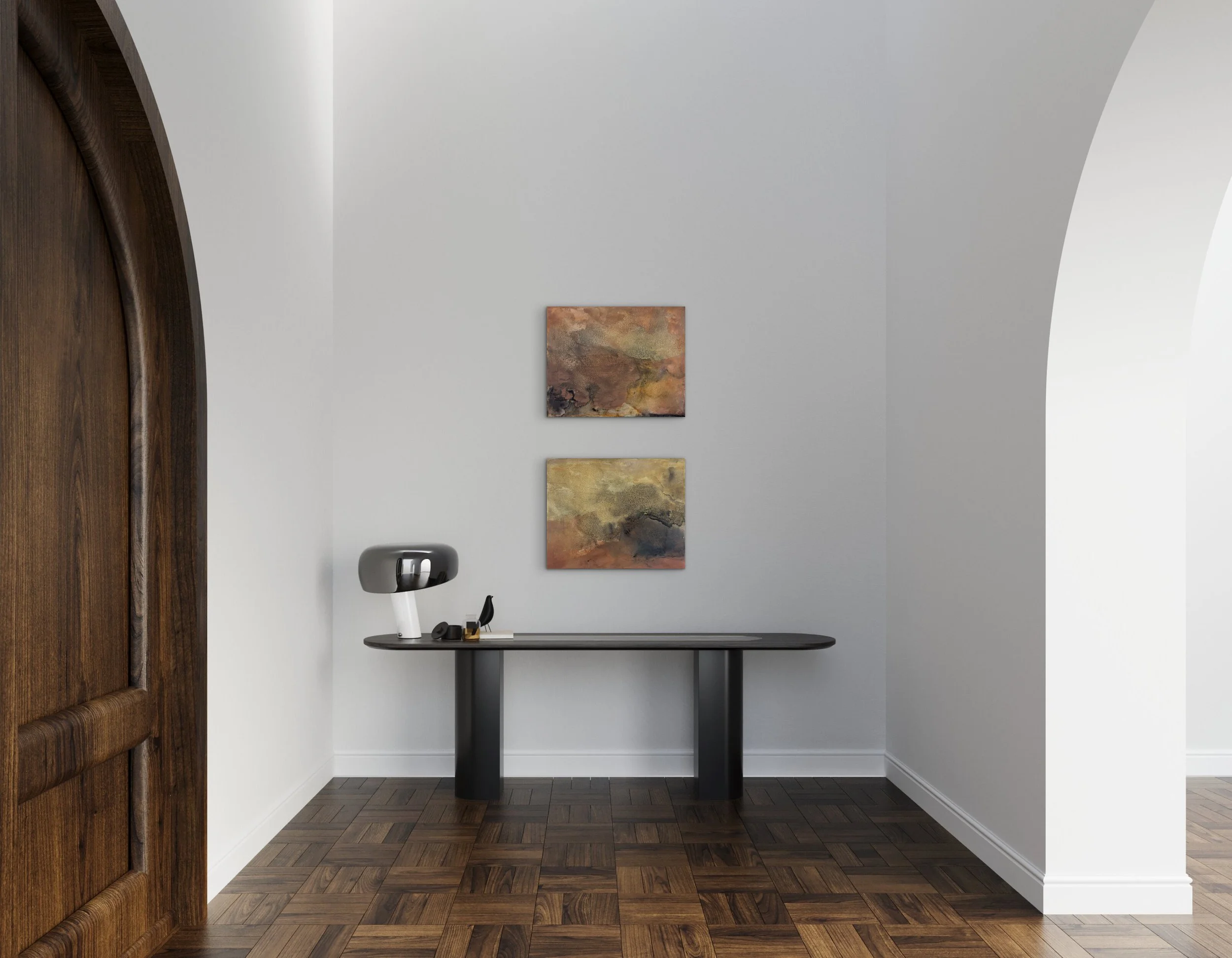 Two abstract paintings by Melanie Biehle displayed above a console table in a neutral interior