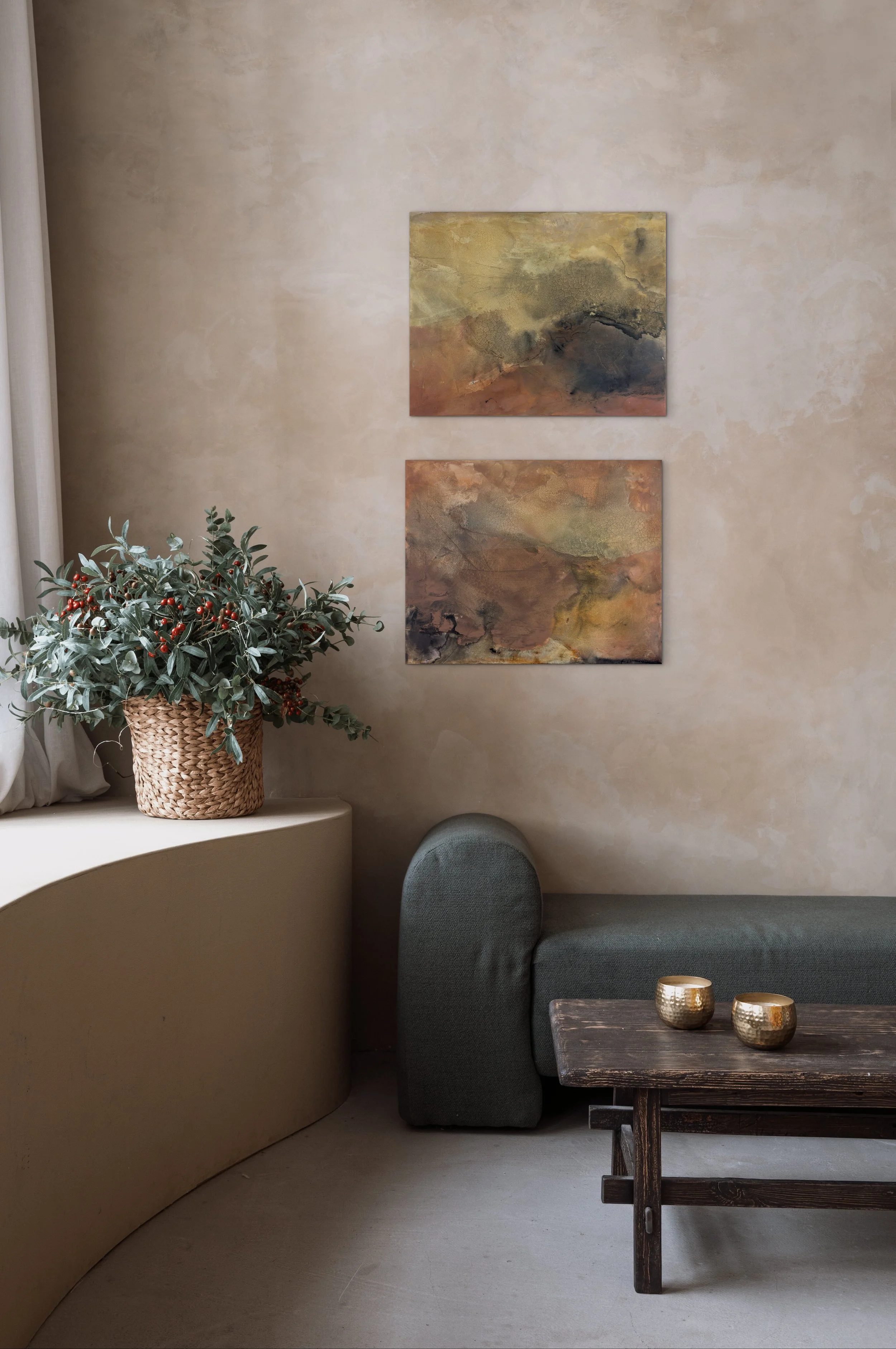Two abstract paintings from the Patina series by Melanie Biehle displayed in a warm-toned interior with textured plaster walls