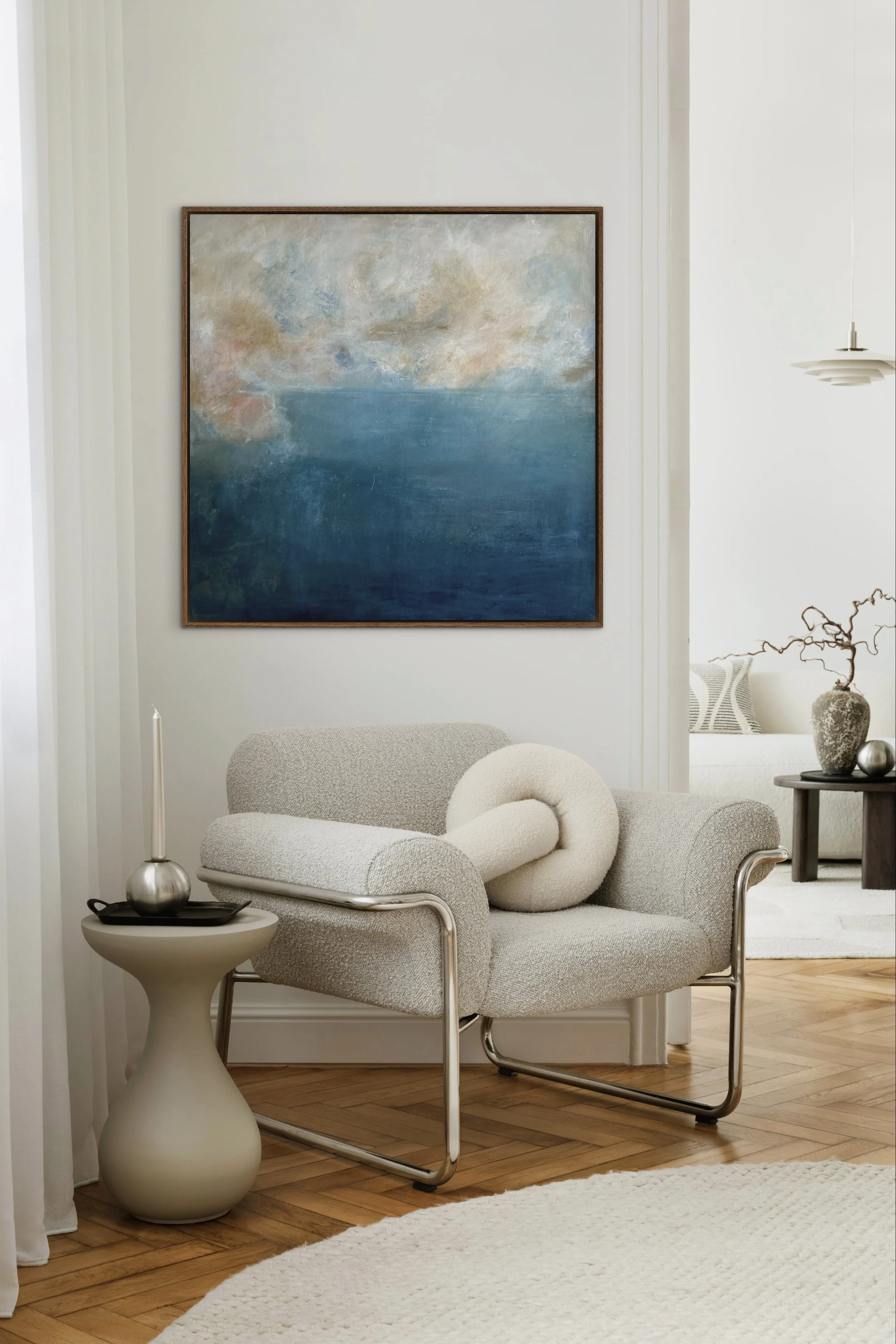 Held by Depth abstract seascape painting displayed in a light, neutral interior