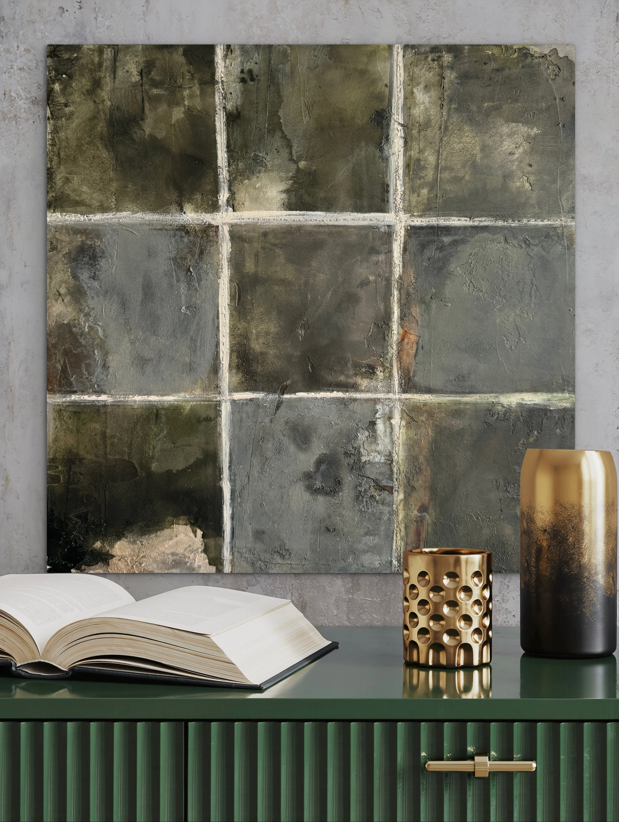 Inhabiting Time No. 2 styled above a dark green console with an open book and sculptural decorative objects.