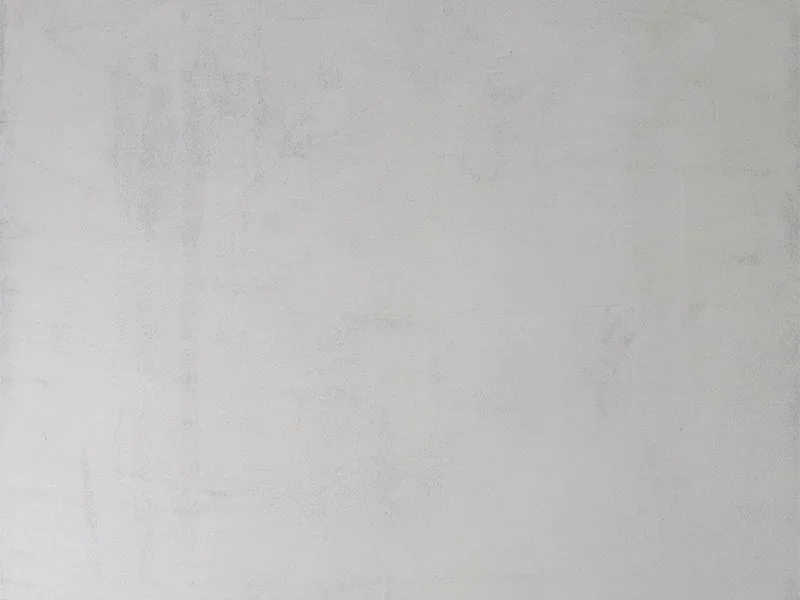 Plain white wall with slight shadow and texture.