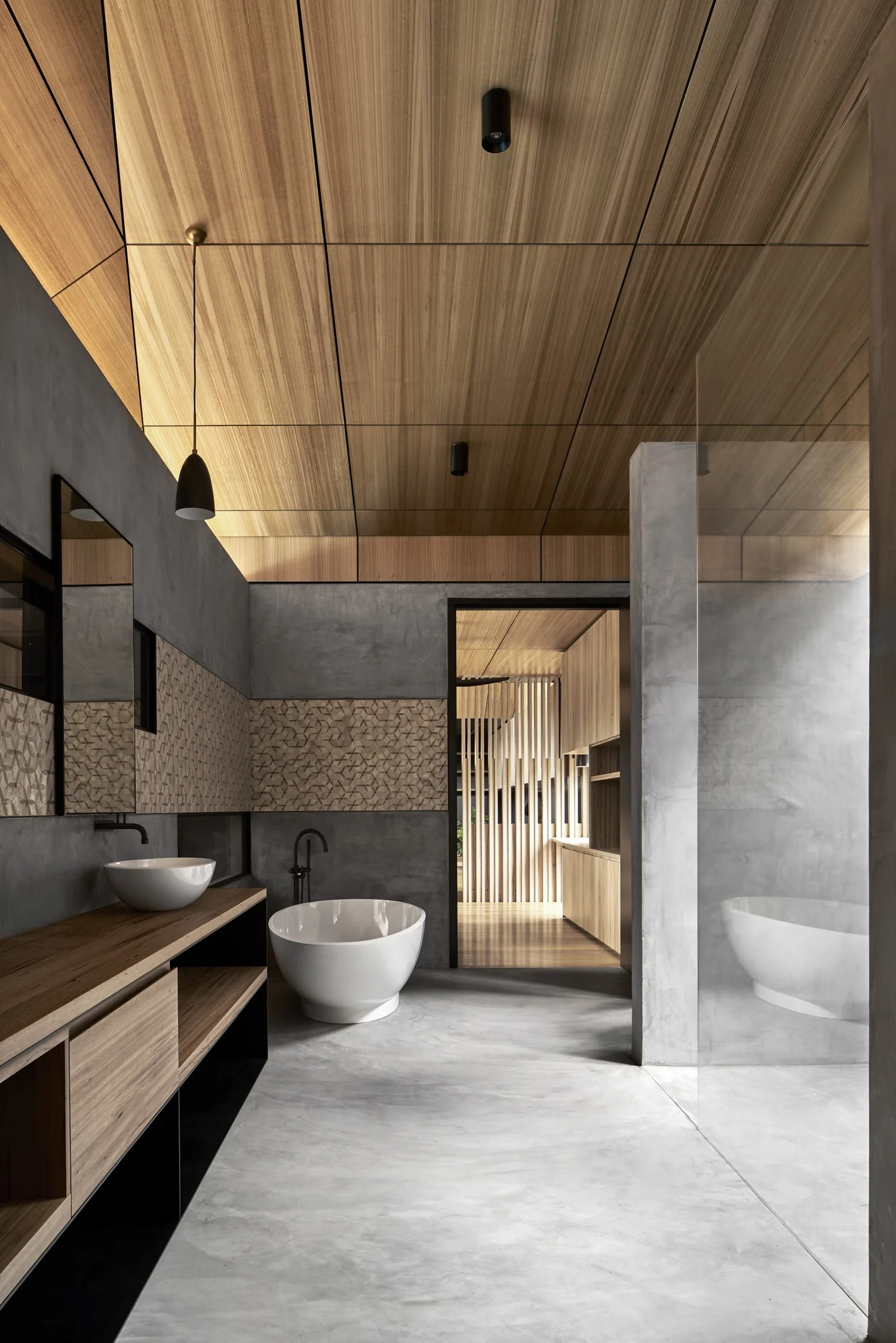 Seamless wall and sculpted basin detail in a completed bathroom