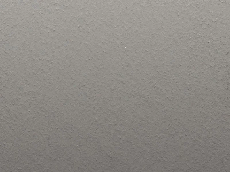 Close-up of a textured gray wall.