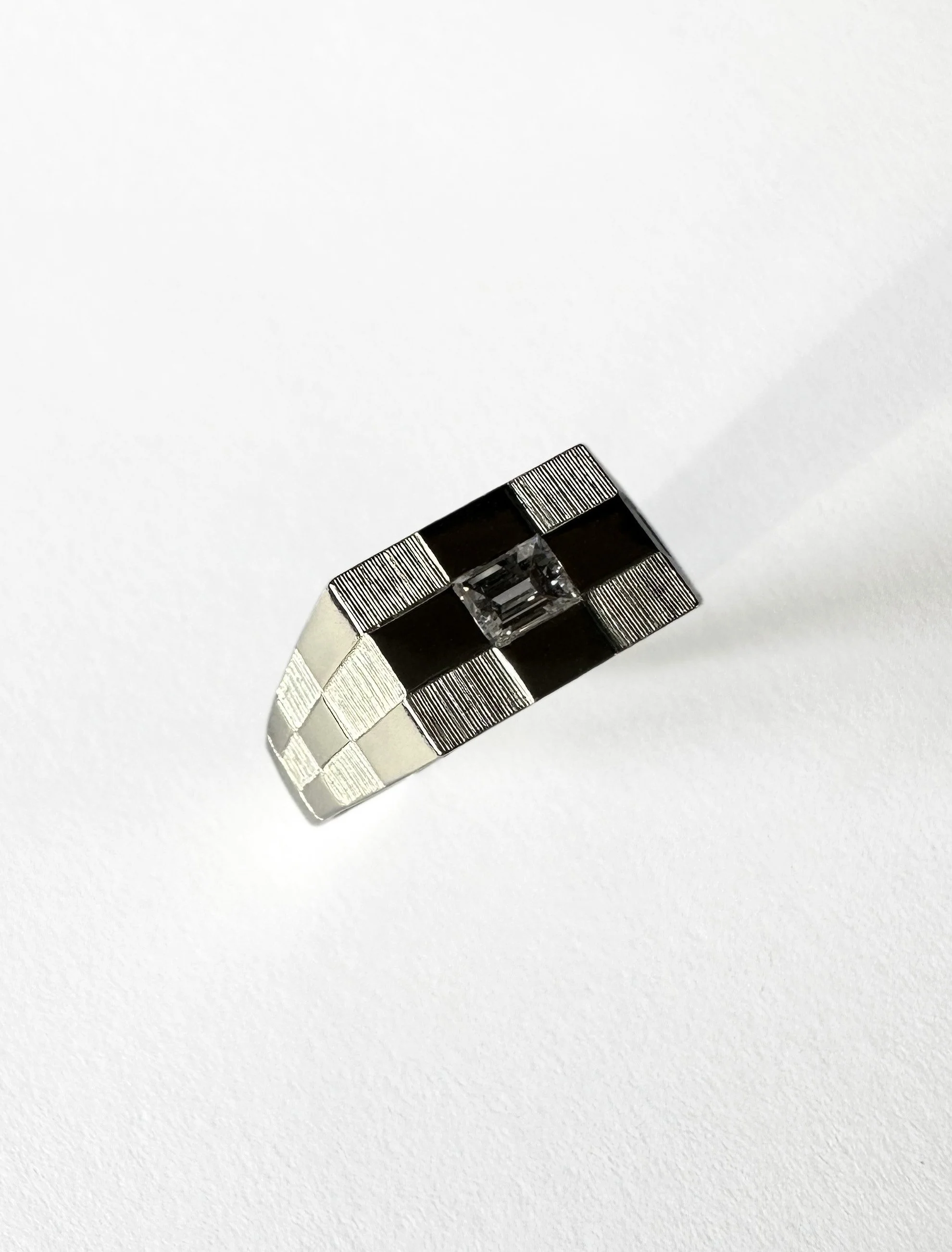 White gold and diamond check ring.