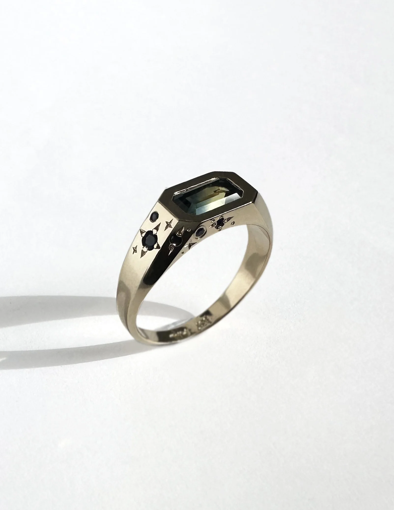 A parti sapphire, ethically hand-mined and cut by @dreamofsapphires, then set in 100% recycled gold. This rectangular sapphire is decorated with engraved stars.