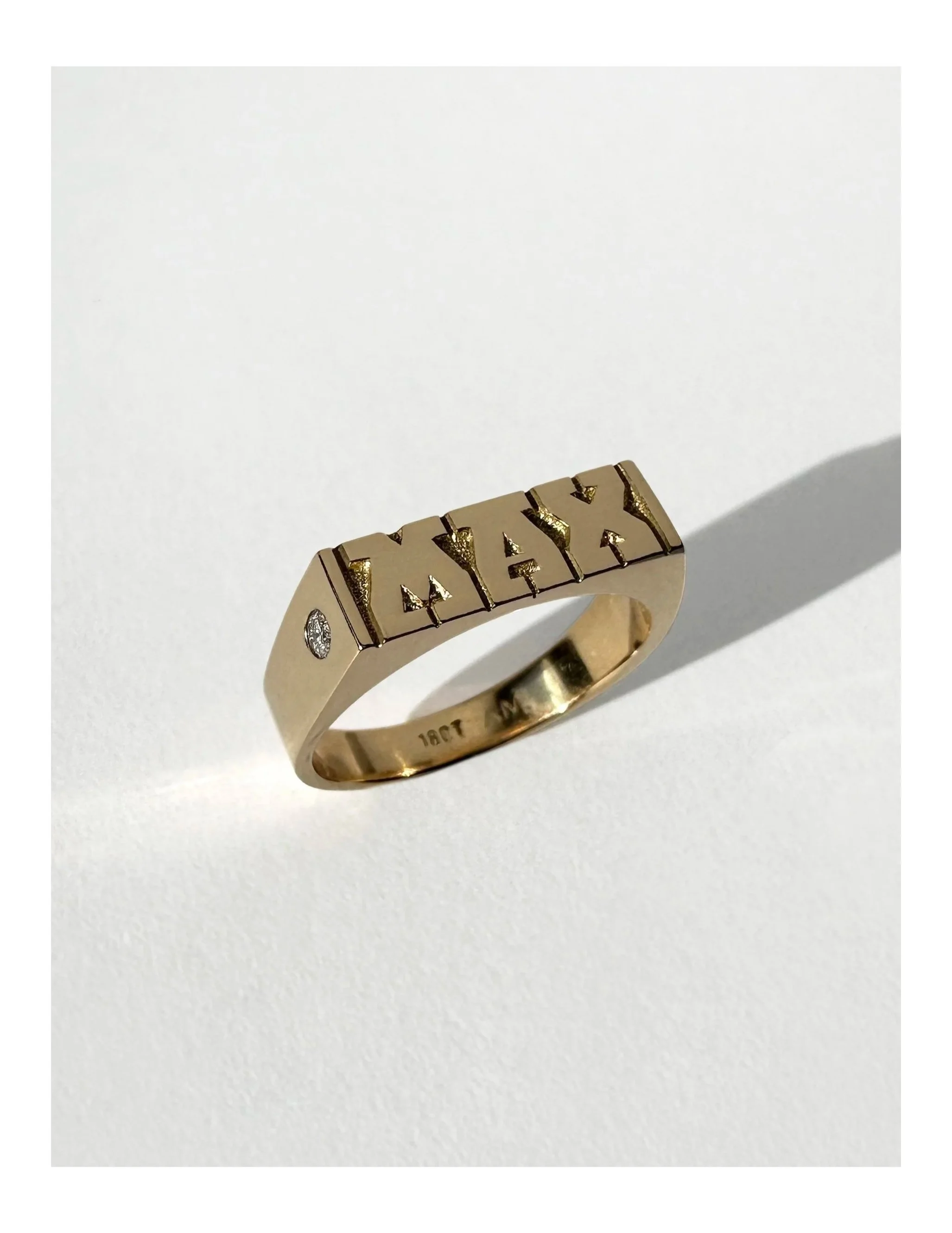 Hand-engraved 18 carat gold wedding ring featuring detailed engraving and a small side diamond. Each piece of jewellery is hand engraved in Melbourne.