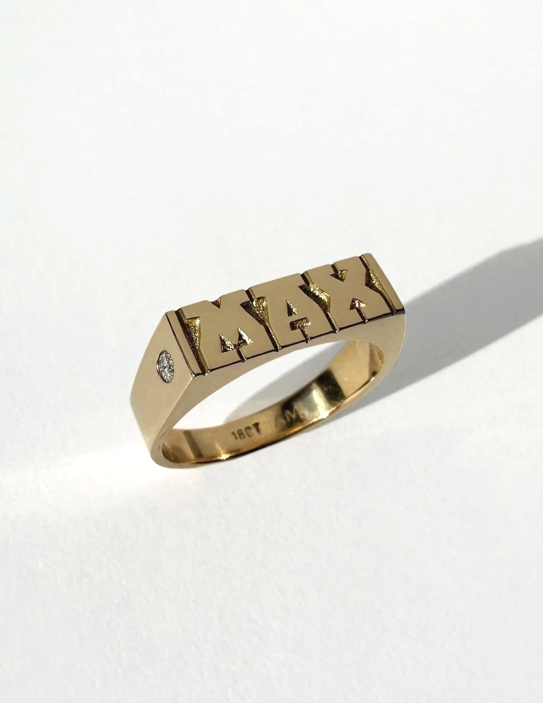 Hand-engraved 18 carat gold wedding ring featuring detailed engraving and a small side diamond. Each piece of jewellery is hand engraved in Melbourne.