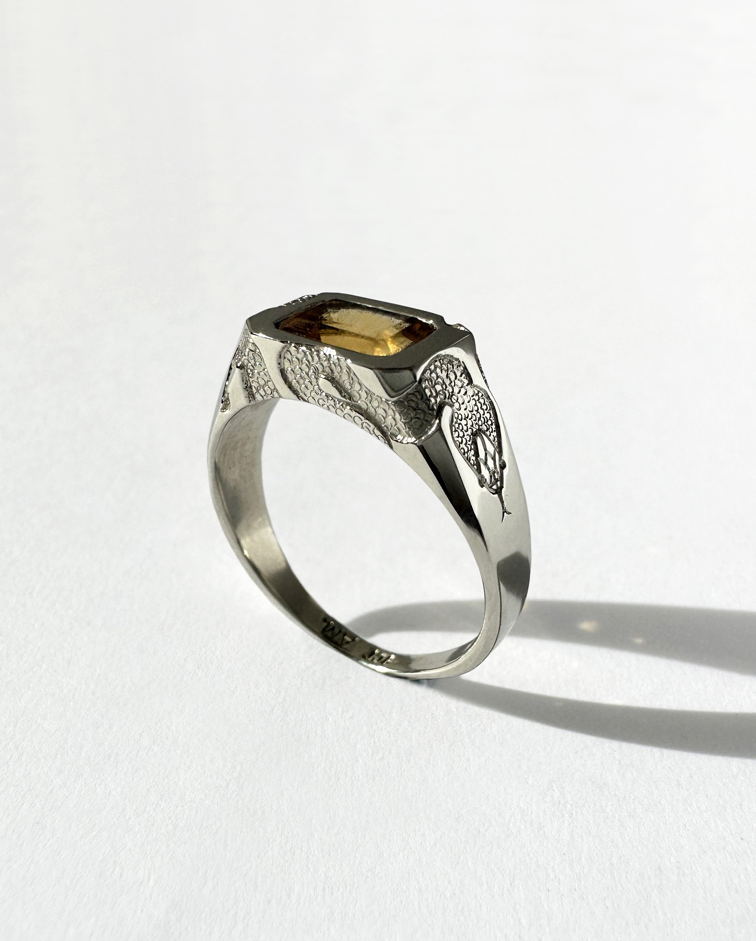 White gold, citrine gemstone and engraved snakes.