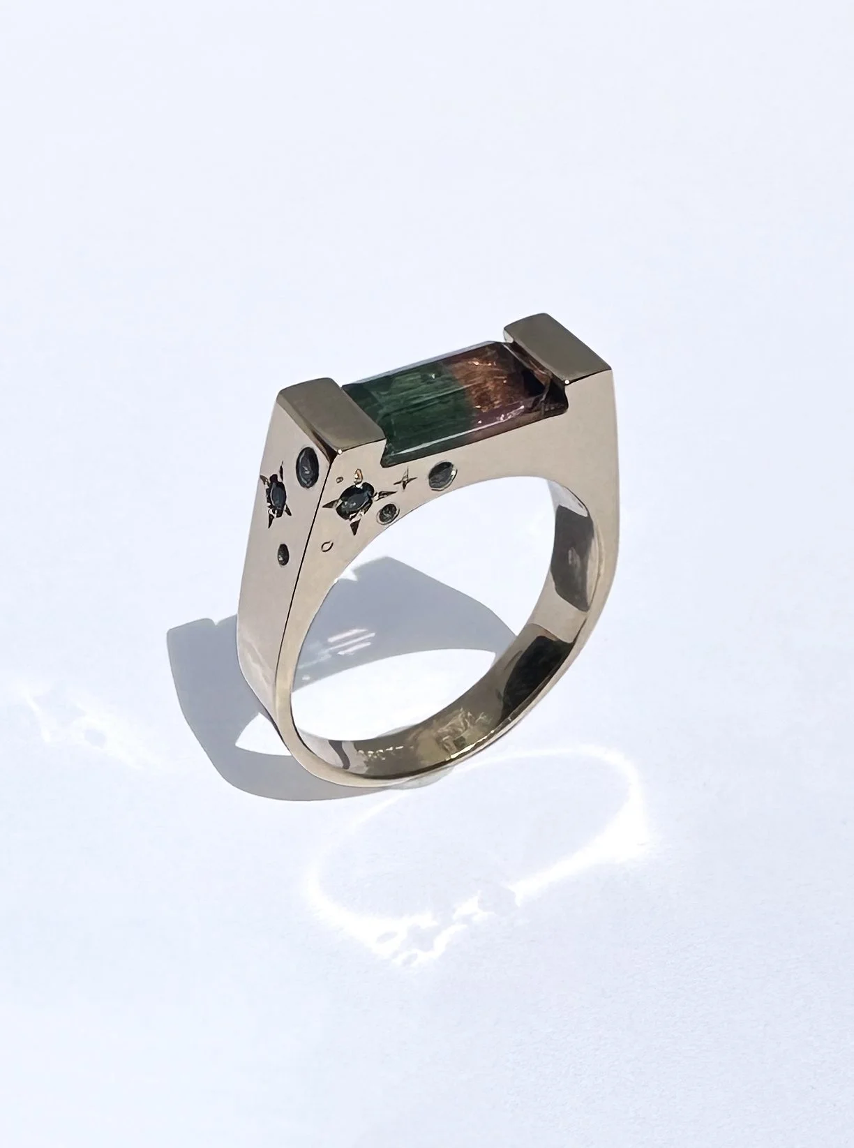 Watermelon tourmaline, set in 18k gold and surrounded by a selection of tourmaline gemstones.