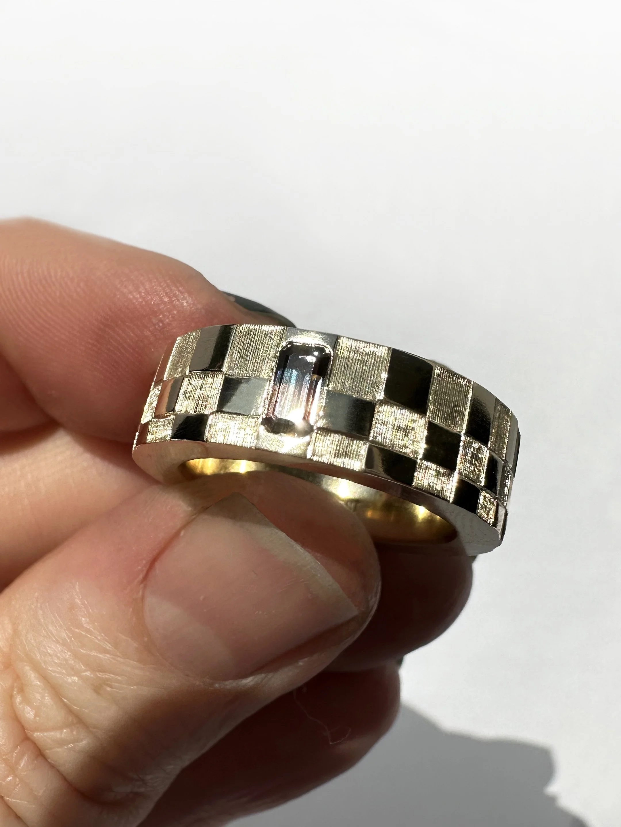 Gradient checkerboard engraving, reflecting a sunset sapphire.