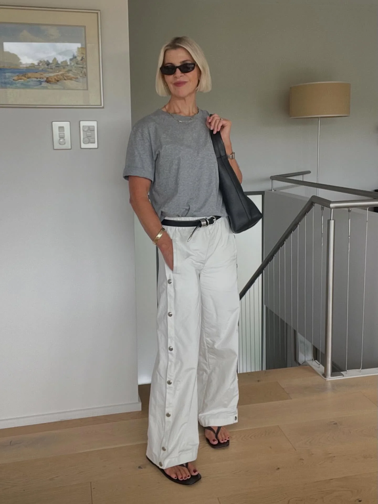 Elevated trackies.
Grey tee, white track pants, black accessories.
Simple pieces styled with intention.