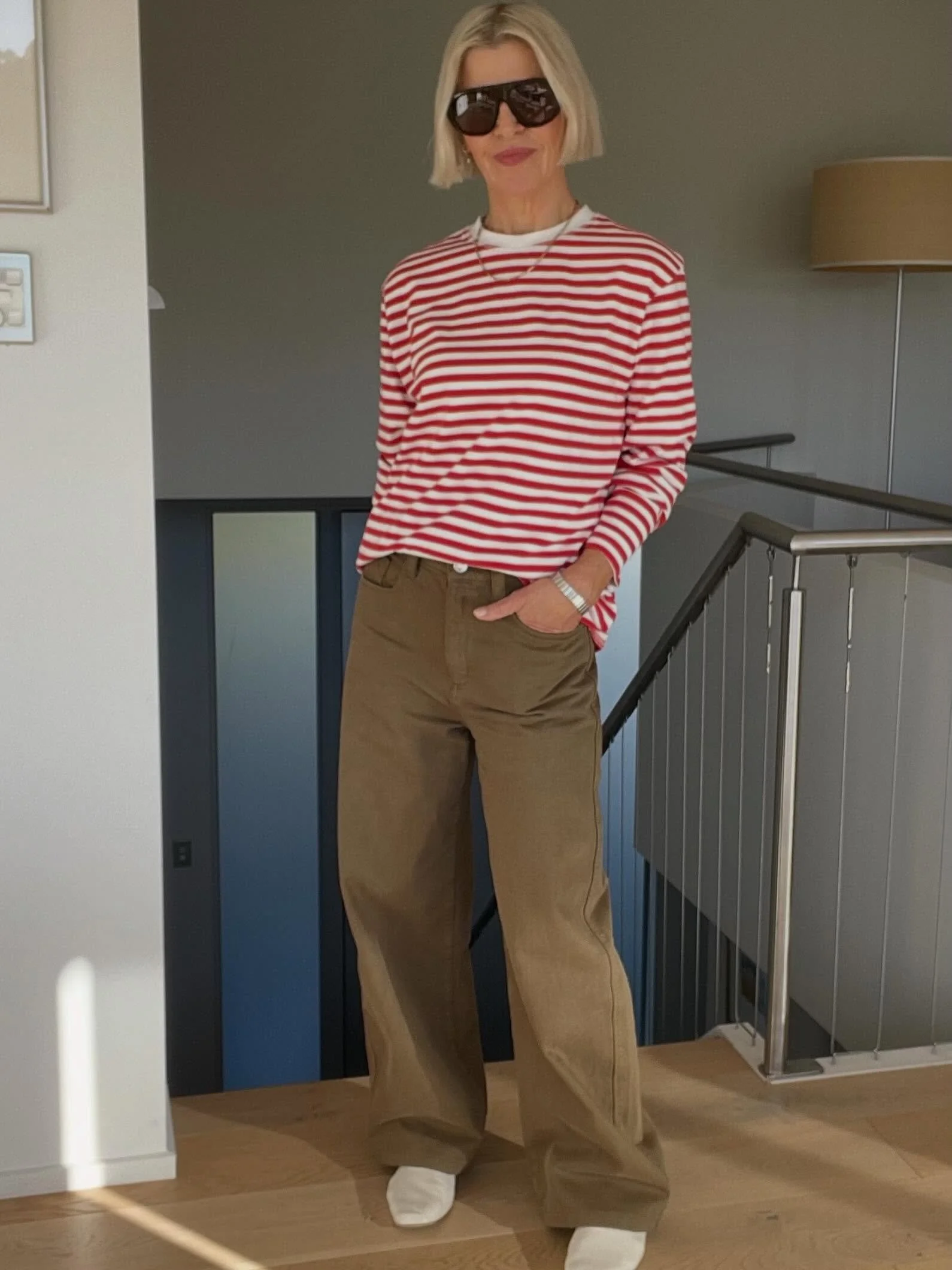 Olive green jeans, two days in a row.

Day 1: red and white Breton tee, half tucked, cream ballet flats. 

Day 2: red top layered over a white singlet, white jazz shoes, the singlet just peeking out at the hem.

Same jeans. Same colour story: red, wh