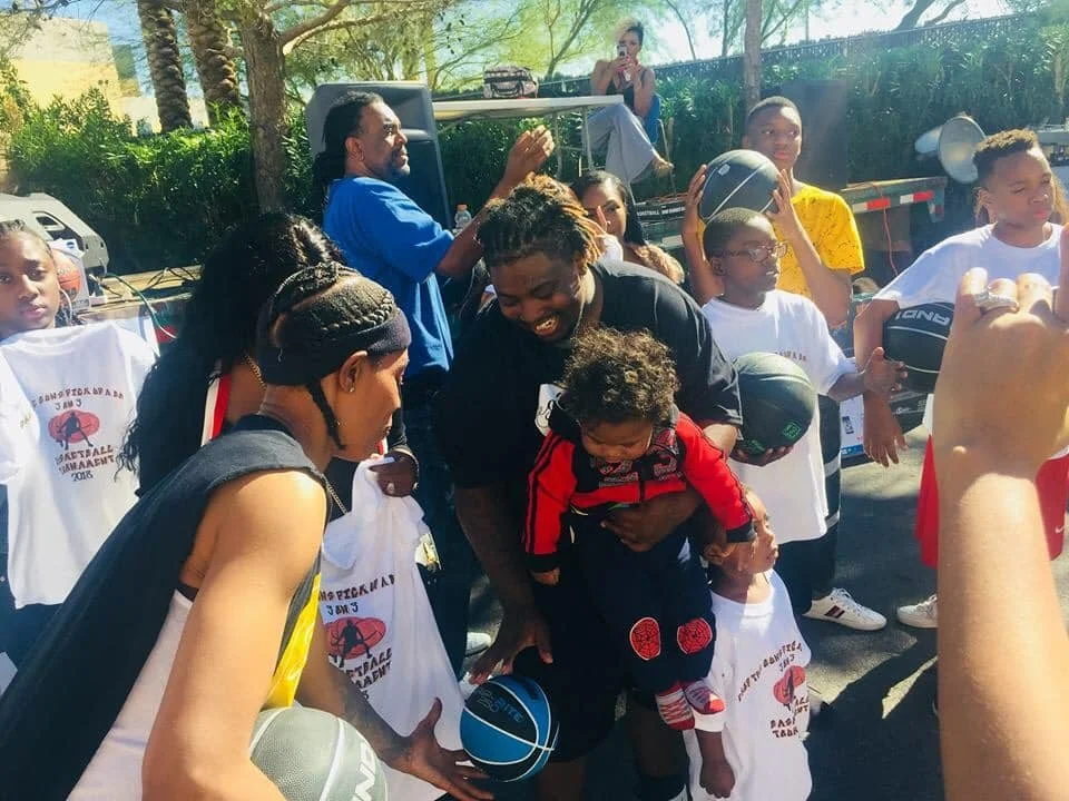 Vegas Black Pride 2018, Group of children and adults playing with basketballs outdoors during 1st Annual Drop the guns pick up a ball community event.