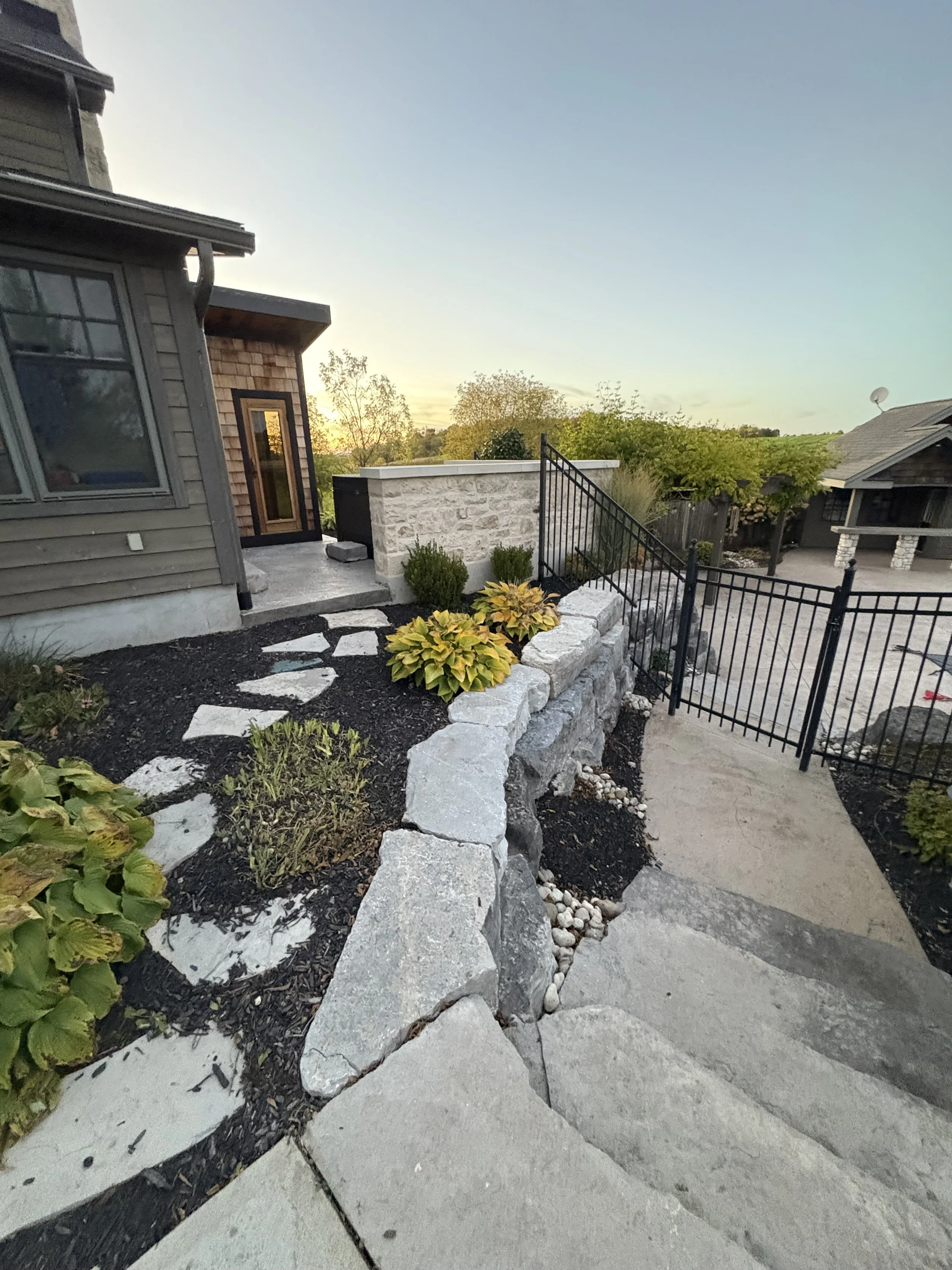 Stone feature wall and armour stone retaining wall.
