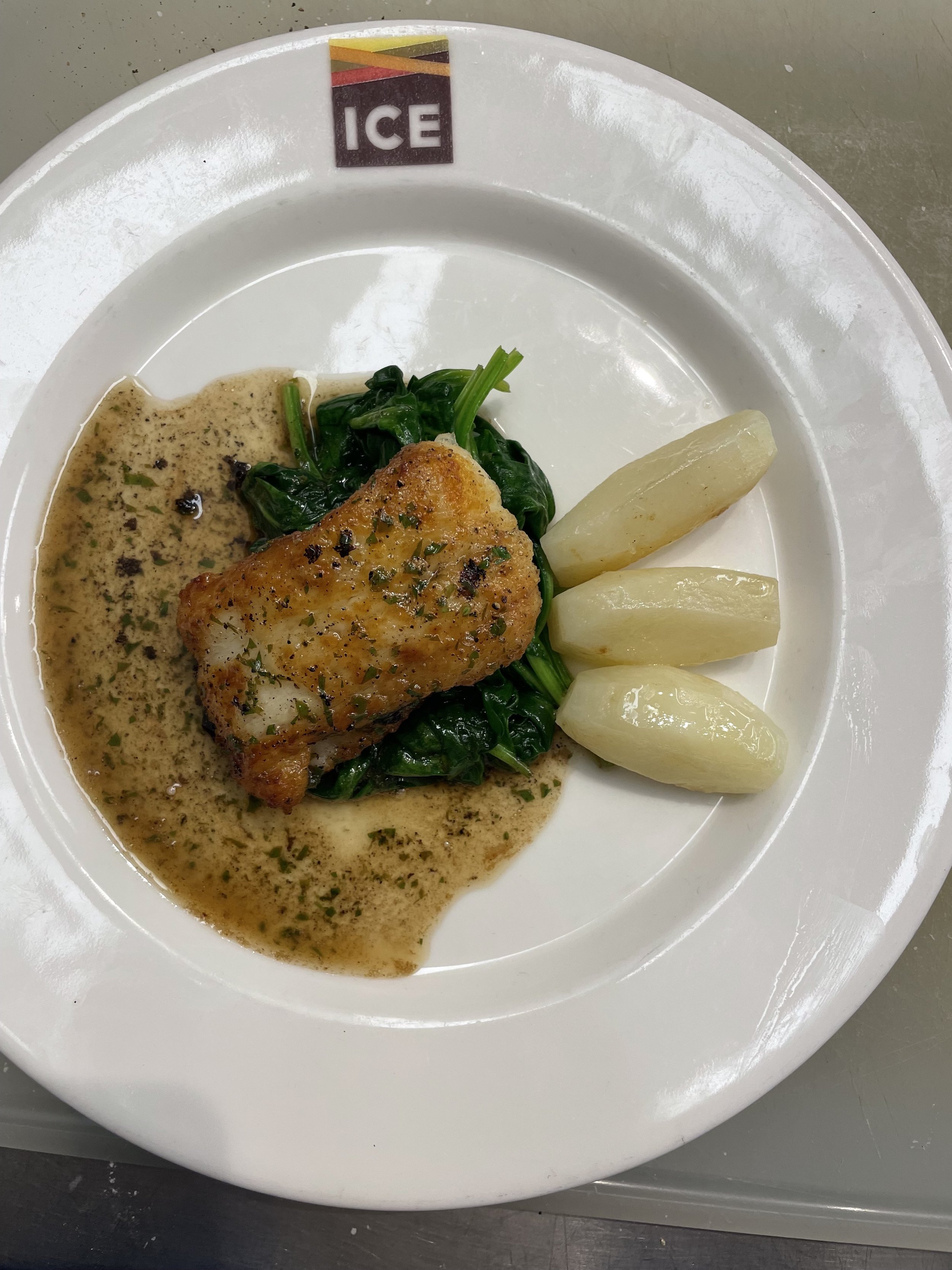 Pan Seared Sole over Sautéed Spinach with Tourné Potatoes and a Brown Butter Lemon Sauce