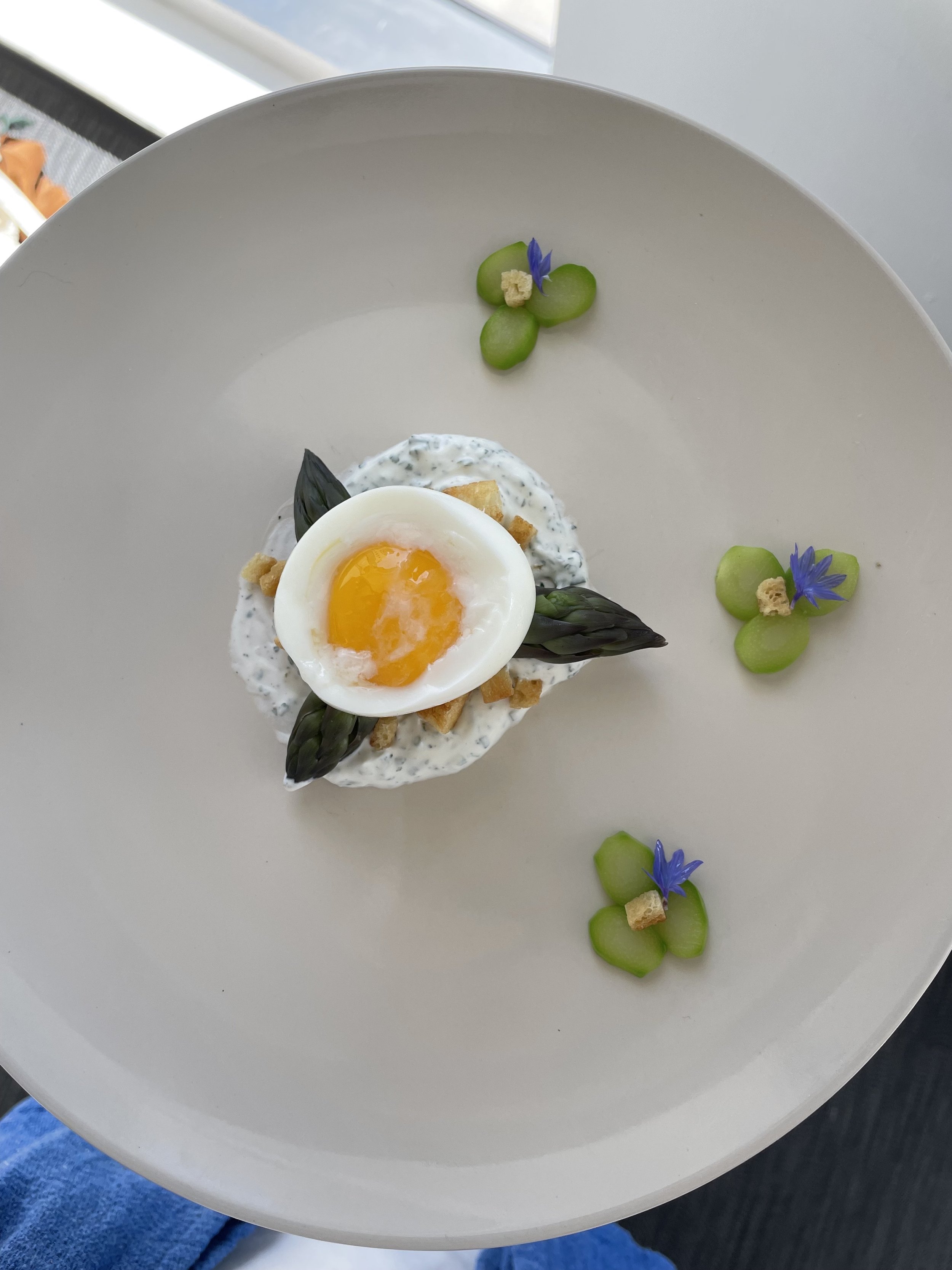 Poached Egg over Yogurt Ranch and Asparagus Tops with Asparagus Stem Flowers