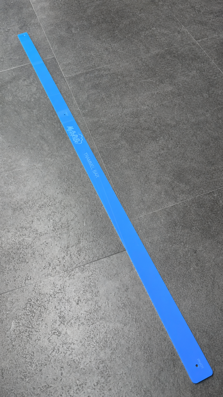 Full-length blue MyScribe Trammel Bar for setting out herringbone and patterned flooring