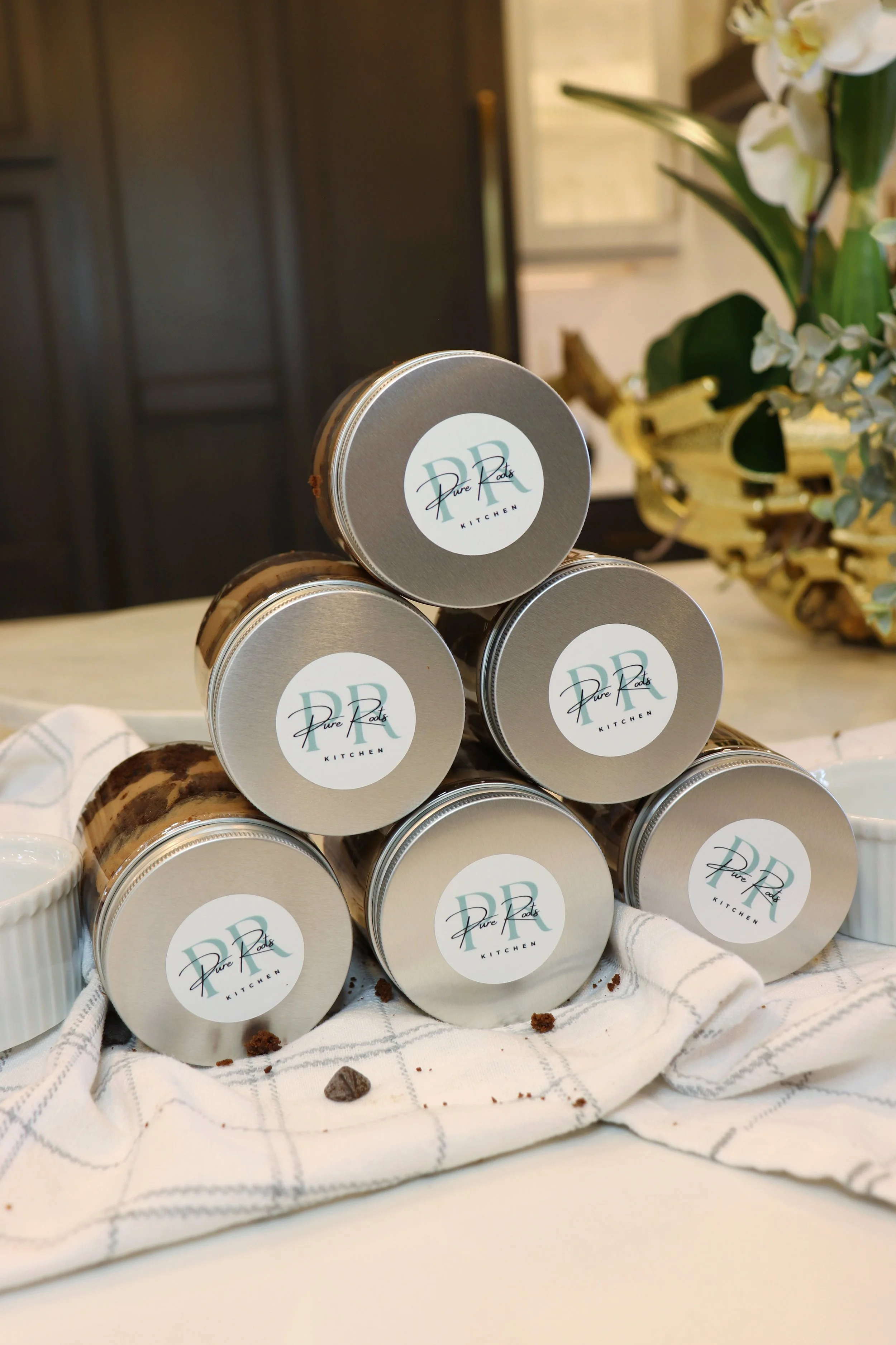 Stack of pure roots kitchen best selling chocolate mousse cake jars made with pure ingredients like coconut cream, coconut sugar, and maple syrup 