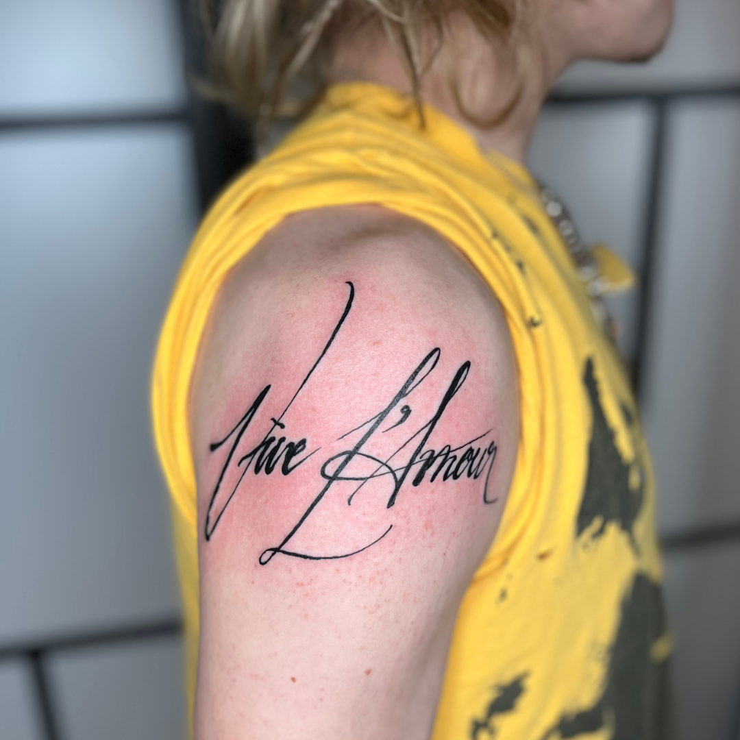 Custom cursive font tattoo saying Vive L'amour