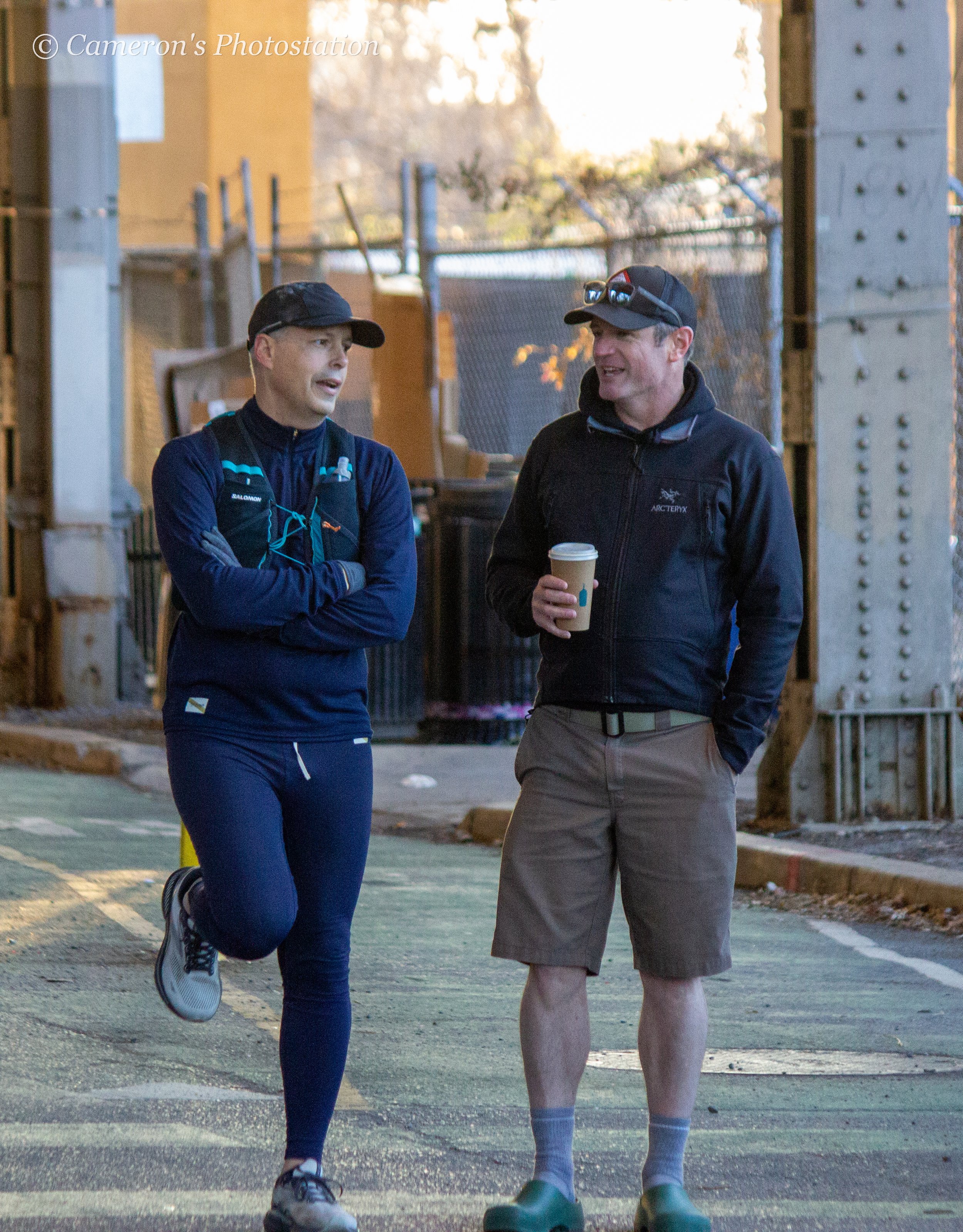Two coaches chatting whilst everyone else works.