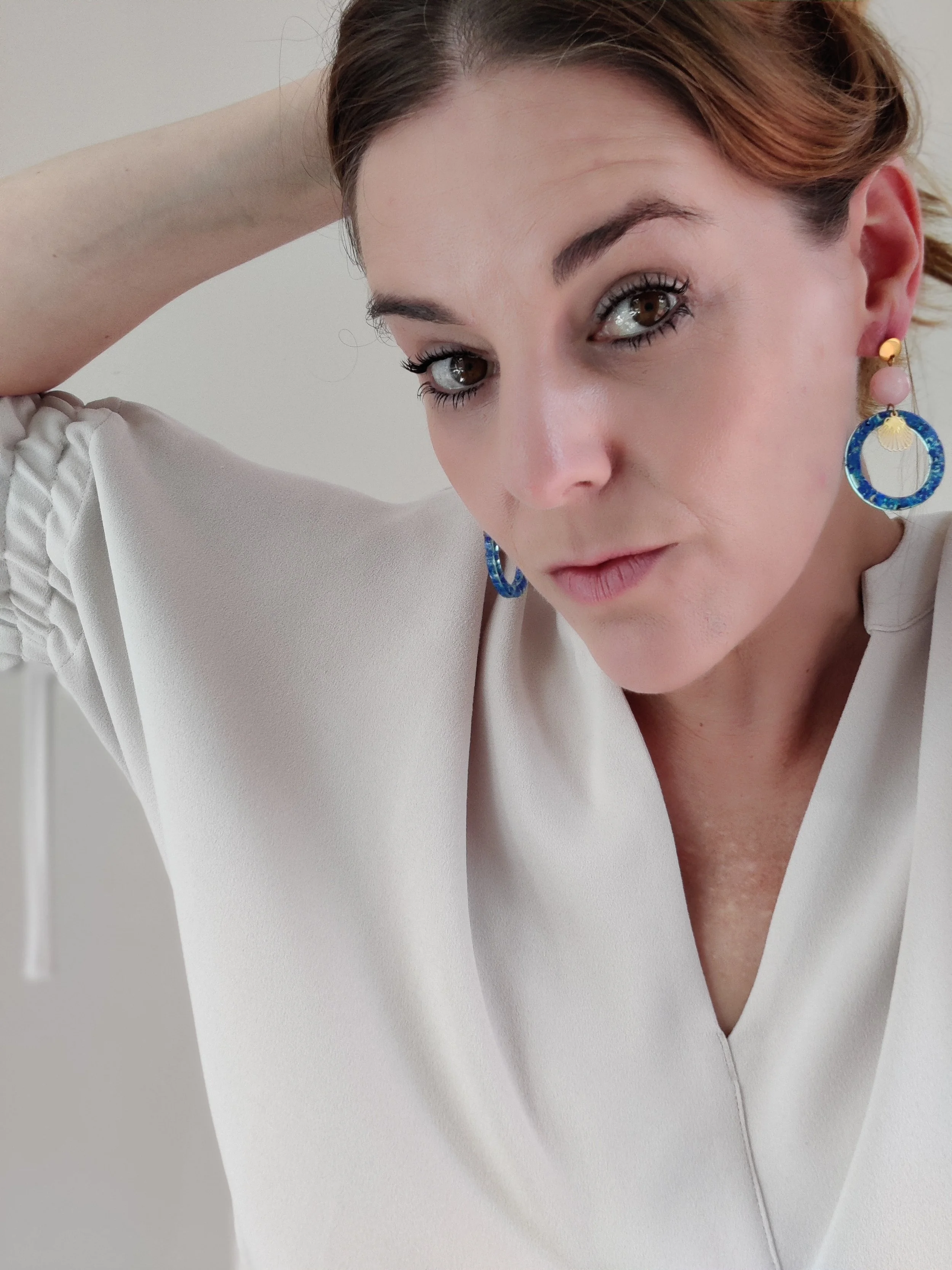 Art Deco–Inspired Blue Opal Hoop Earrings with Shell Detail on person.jpeg