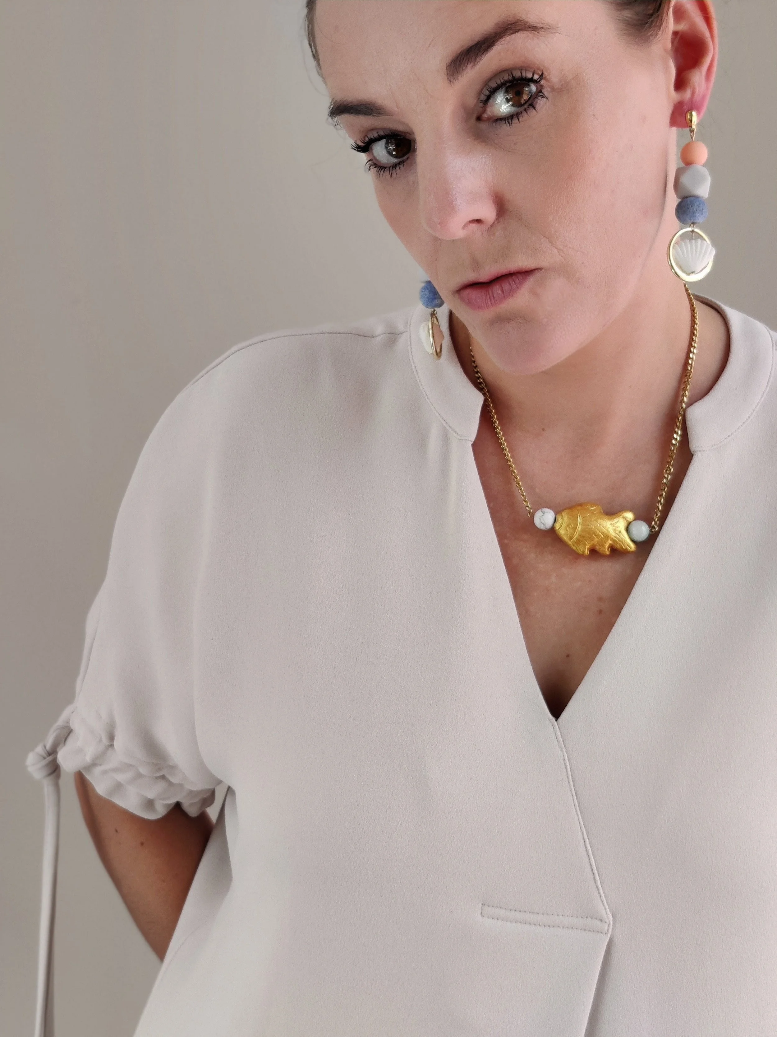 Maritime Shell Drop Earrings with Repurposed Blue Coral Beads on person.jpeg