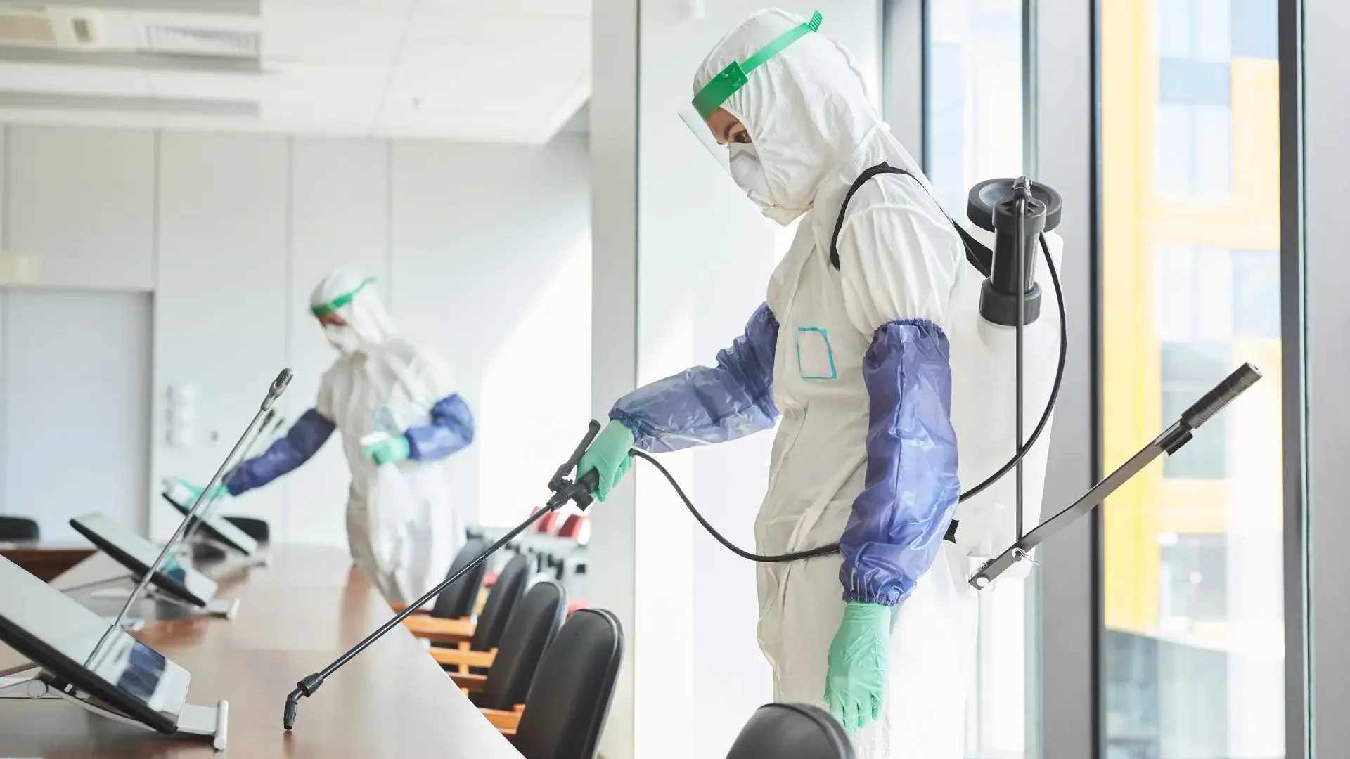 professional cleaning team sanitizing high-touch surfaces in office in Austin TX