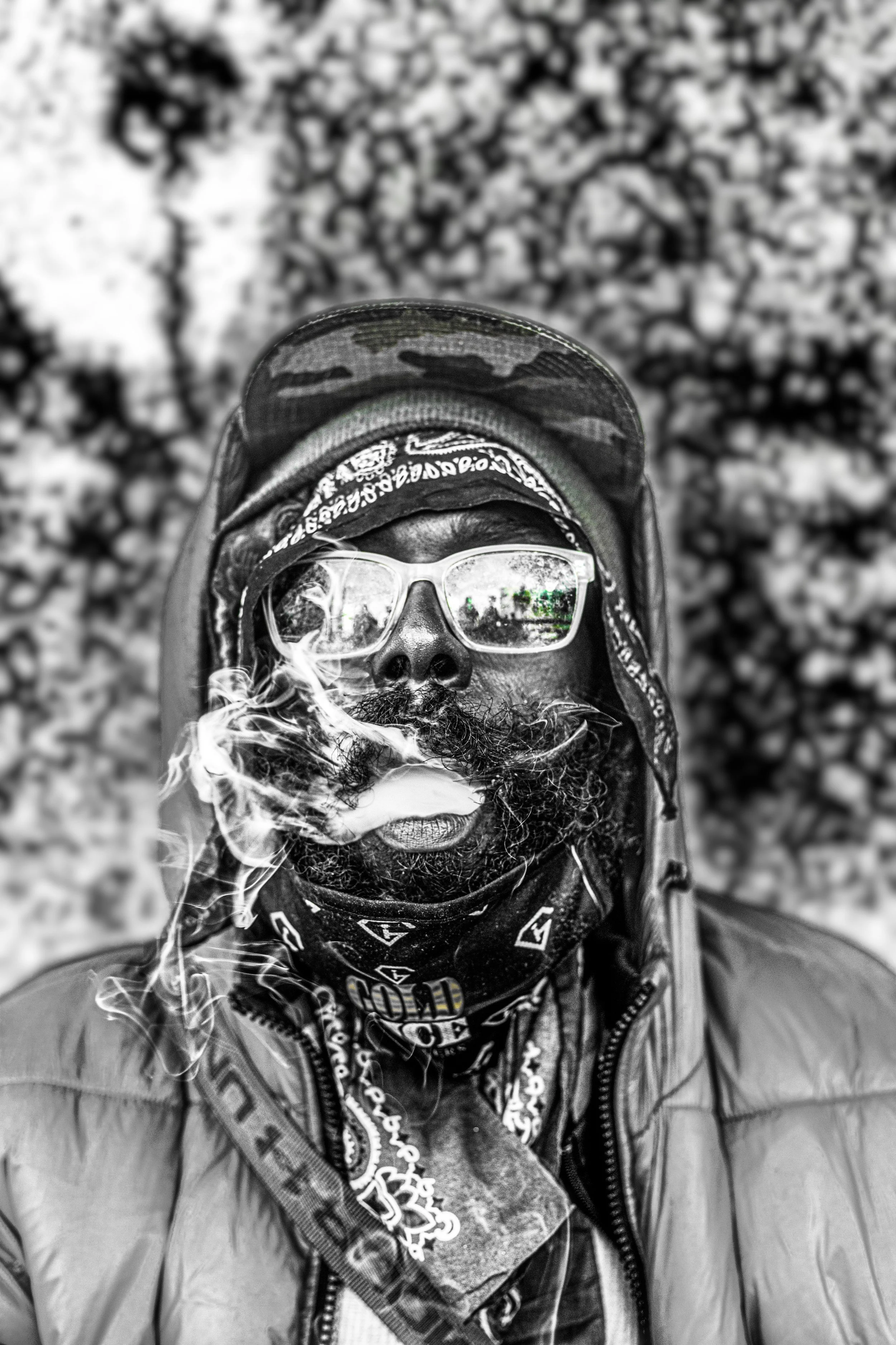 “Between identity and oblivion, the human being remains—watching, breathing, and carrying the weight of his own existence. Behind the glasses, the world is reflected; behind the smoke, a life refuses to disappear.”
“Between identity and oblivion, the