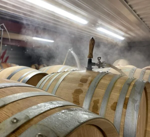 Prepping barrels for wine with steam cleaner