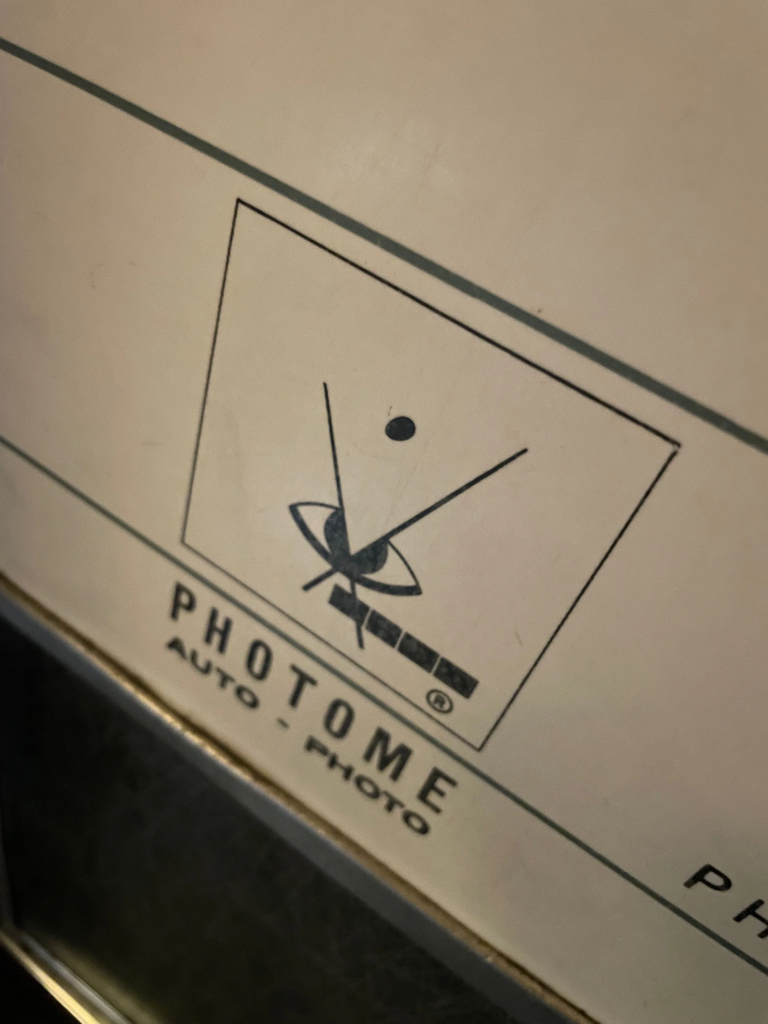 Original door signage with horizontal lines showing both the Photo-Me and Auto-Photo vintage photo booth logo branding