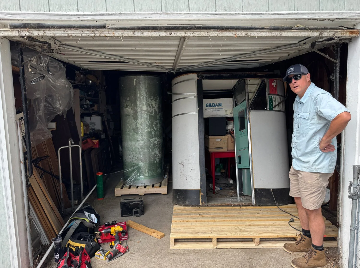two model 11 vintage photobooths inside small garage