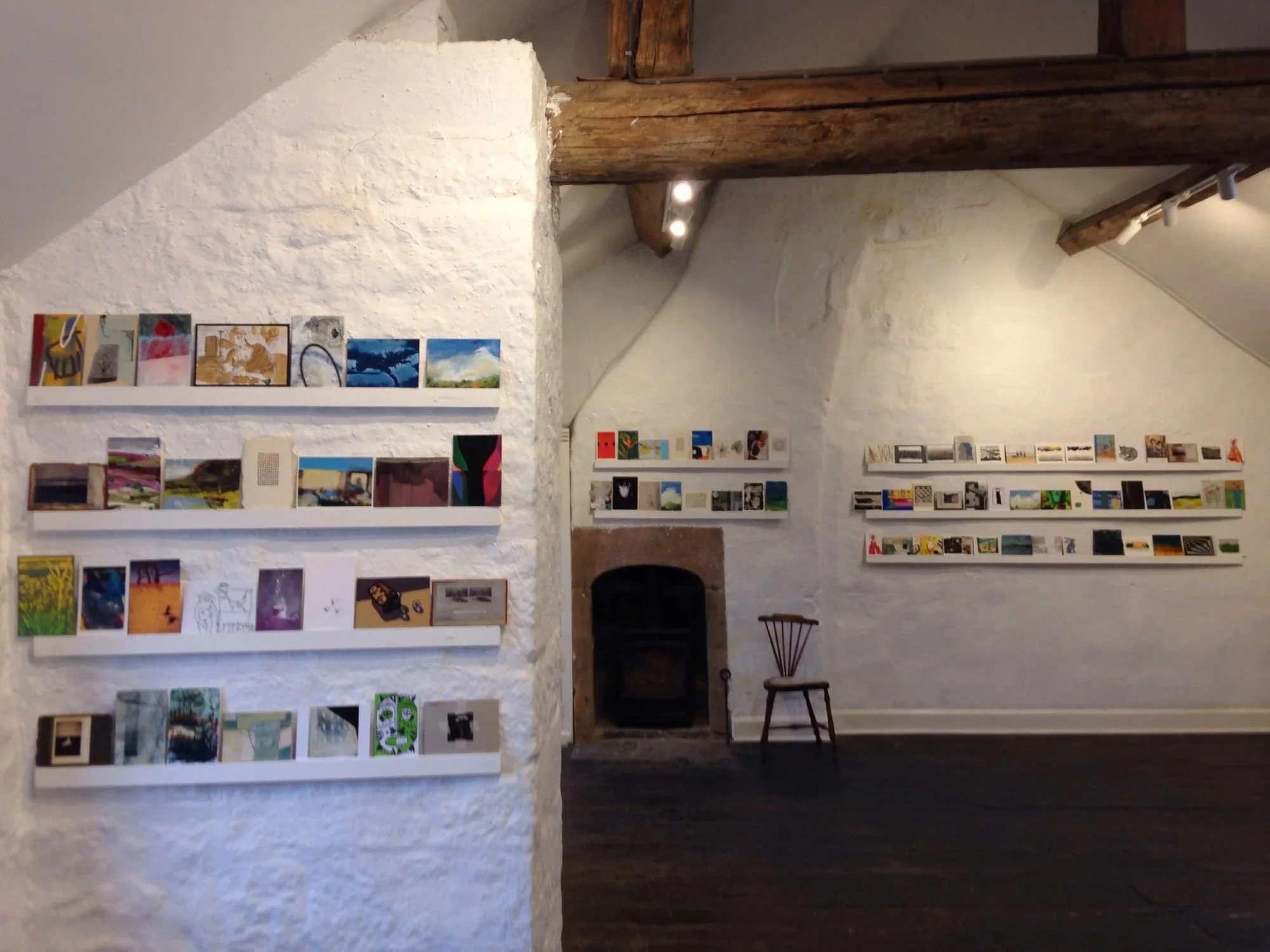 Postcards displayed on batons in The Old Lock Up Gallery Cromford