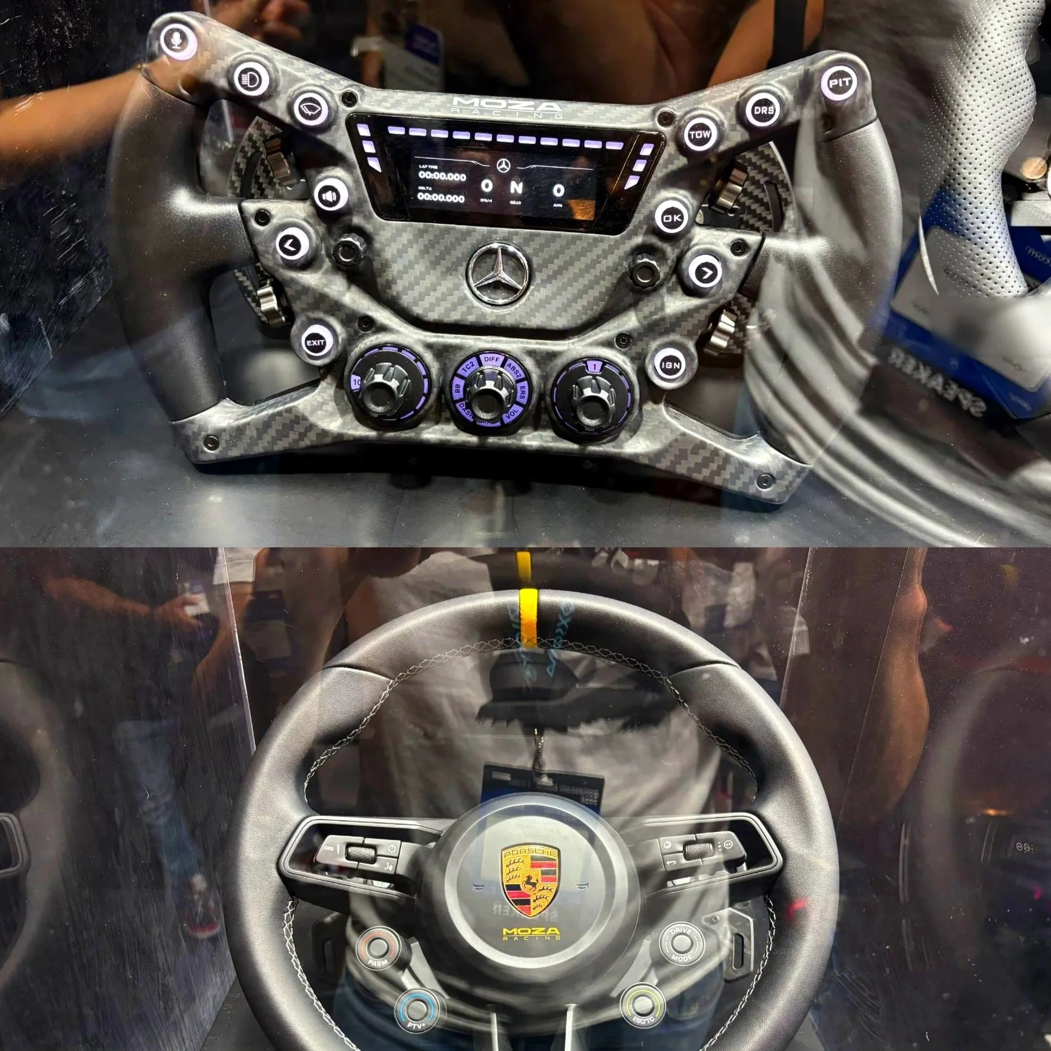 Close-up of a Porsche racing car steering wheel with various buttons and controls, display screen, and the Porsche logo in the center.