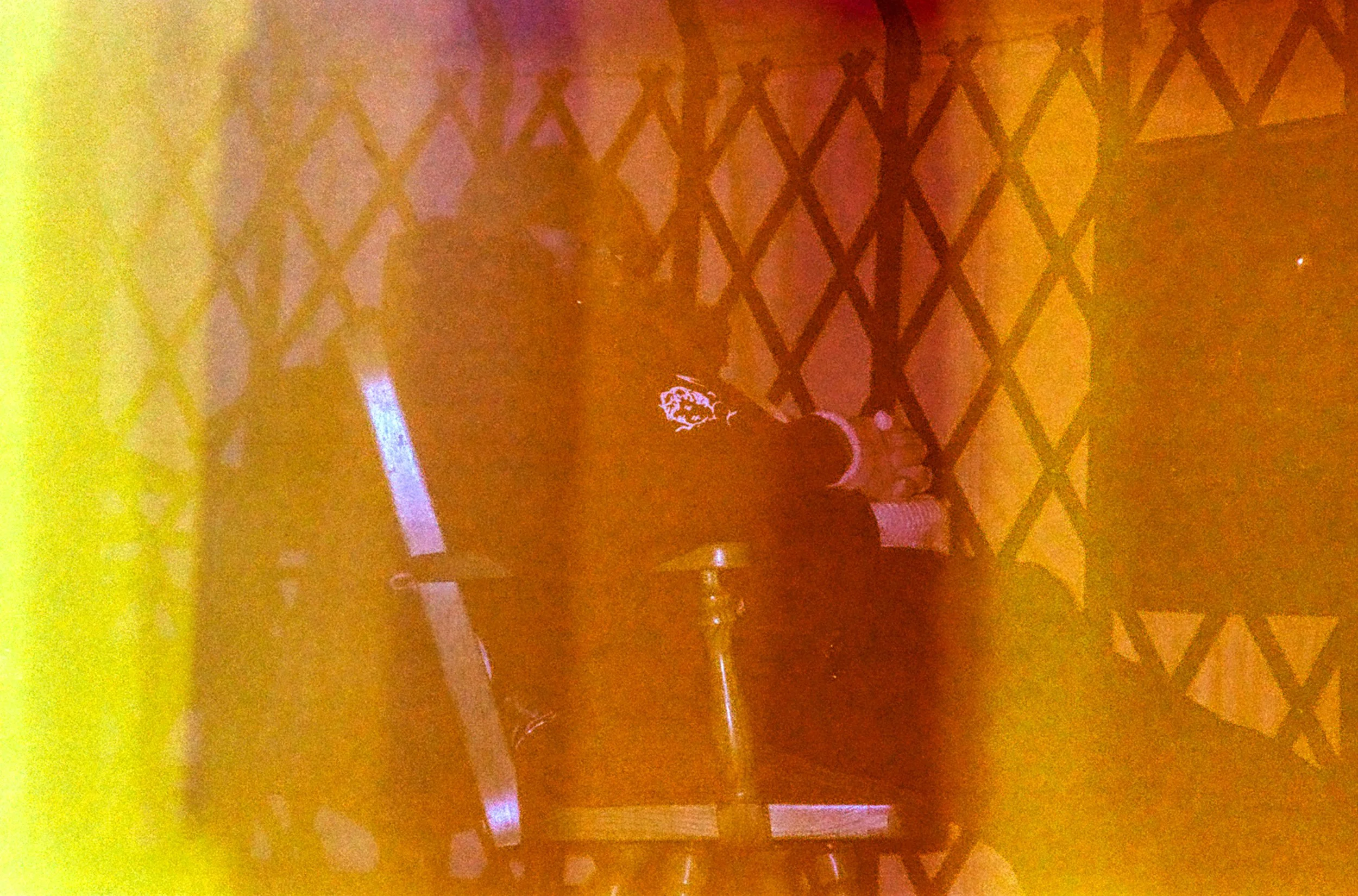 A man sitting at a table in a dimly lit room.