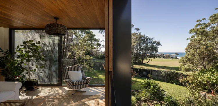 Living area opening through glazing to the garden and ocean beyond, Coledale extension