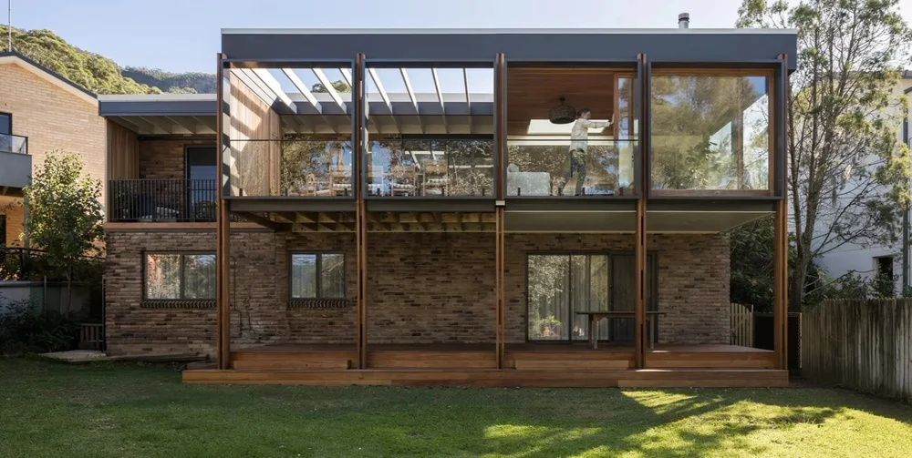 Rear living extension and balcony framed by paired timber posts, Elanora Four renovation in Coledale by CKS Projects