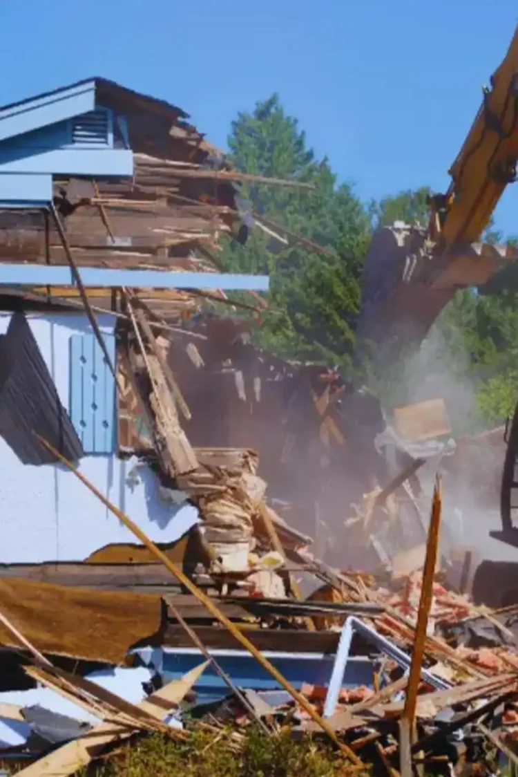 Excavator demolishing an old weatherboard house before a knockdown rebuild