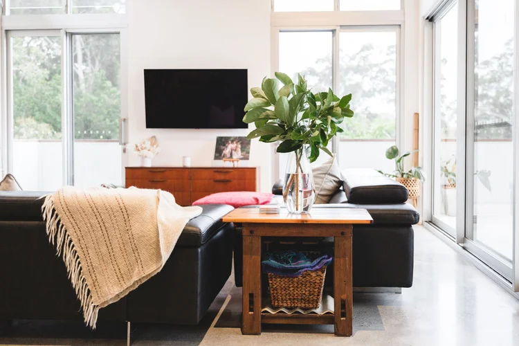 Light-filled living room with high windows in a Woonona home by CKS Projects