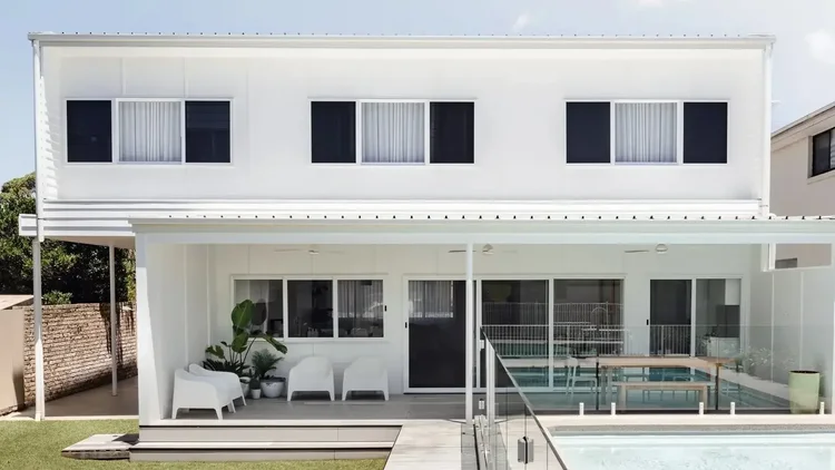 White two-storey new home with a swimming pool, built by CKS Projects