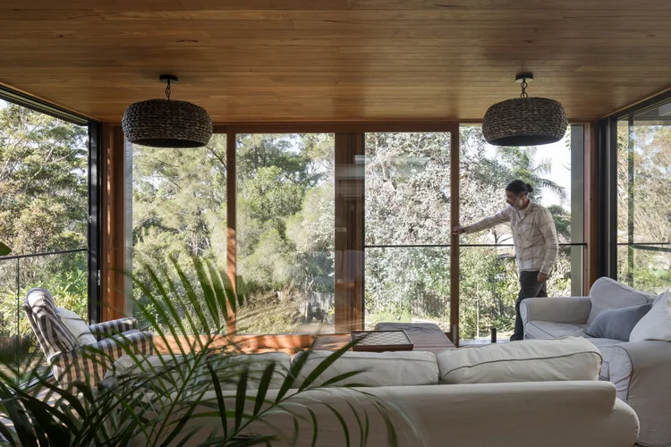 Renovated living room with a timber-lined ceiling and floor-to-ceiling glazing, Elanora Four in Coledale