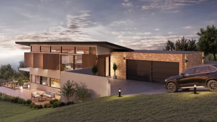 Split-level home stepping down a sloping block at dusk