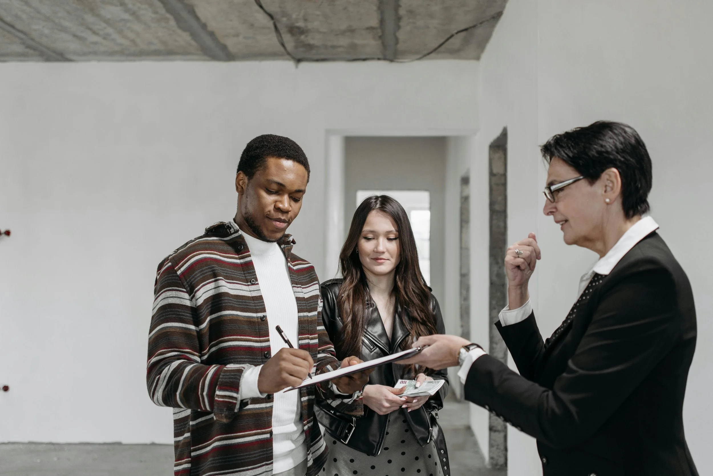 A man signing the property auction form.