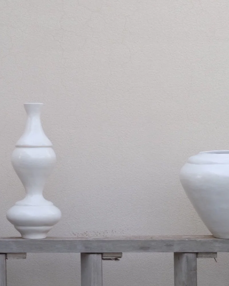 Two hand-coiled SOIO Studio ceramic vases displayed on a shelf