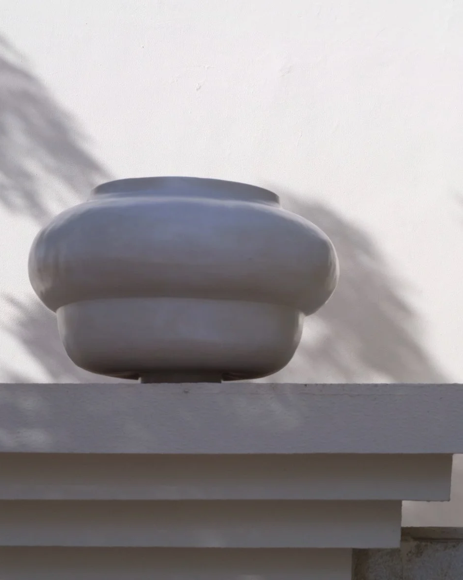 Rounded sculptural Ampla stoneware piece by SOIO Studio, shown on a ledge
