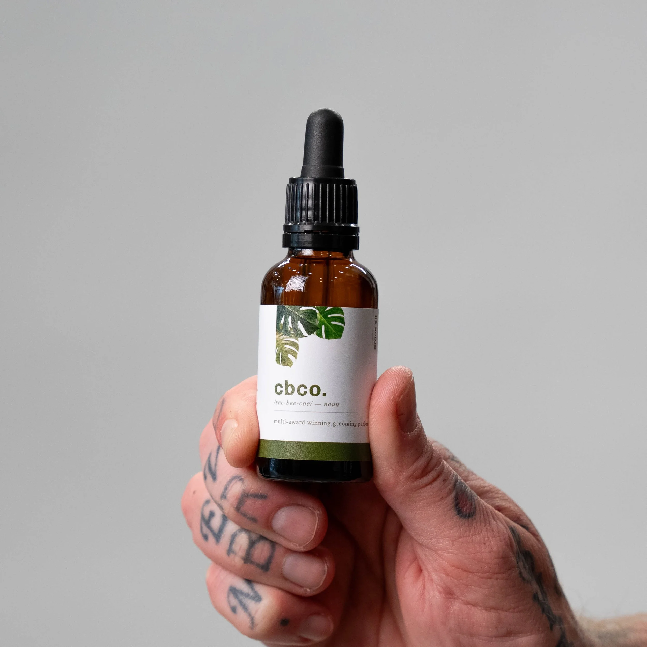Hand holding the cbco argan oil