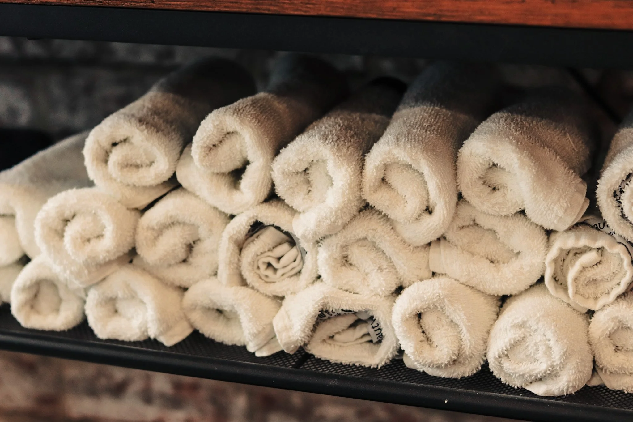 White towels, rolled up, ready to be used at Cresswell Barber in Southampton