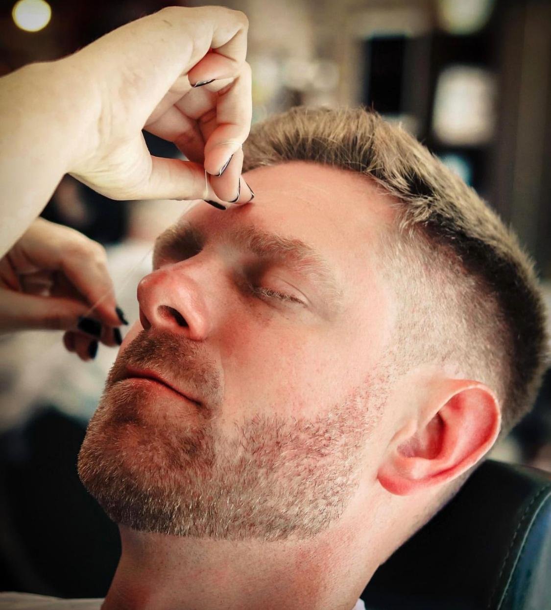 Gent getting his eyebrows threaded at Cresswell Barber in Southampton