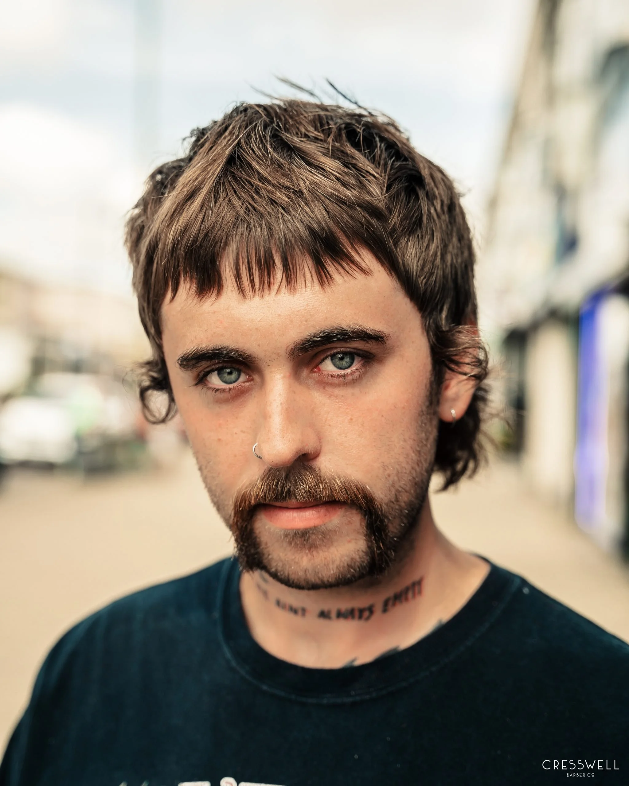 Edgy looking guy with a moustache and long hair-cut, from Cresswell Barbers in Southampton