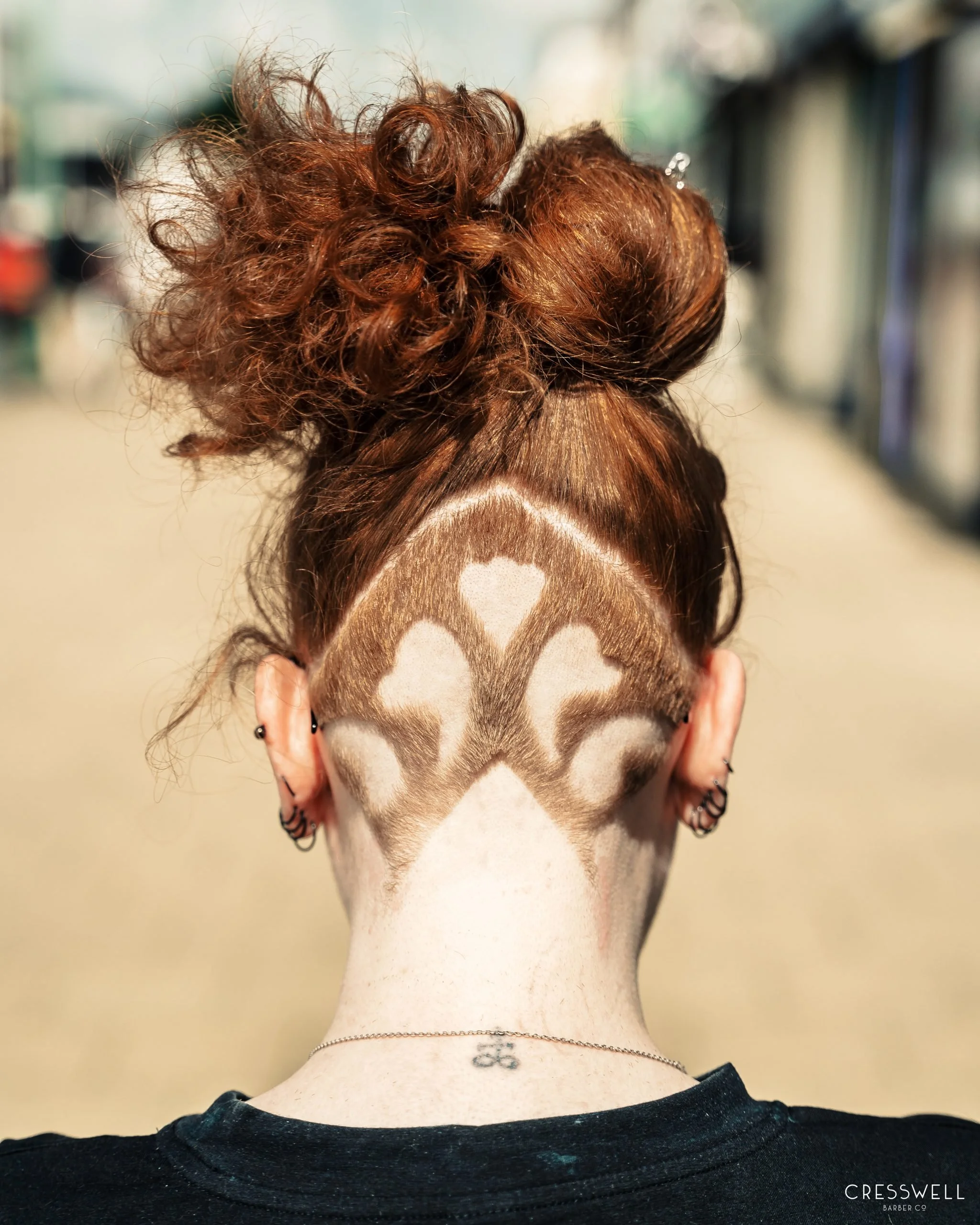Nape pattern on the back of a red-headed female outside Cresswell Barber in Southampton