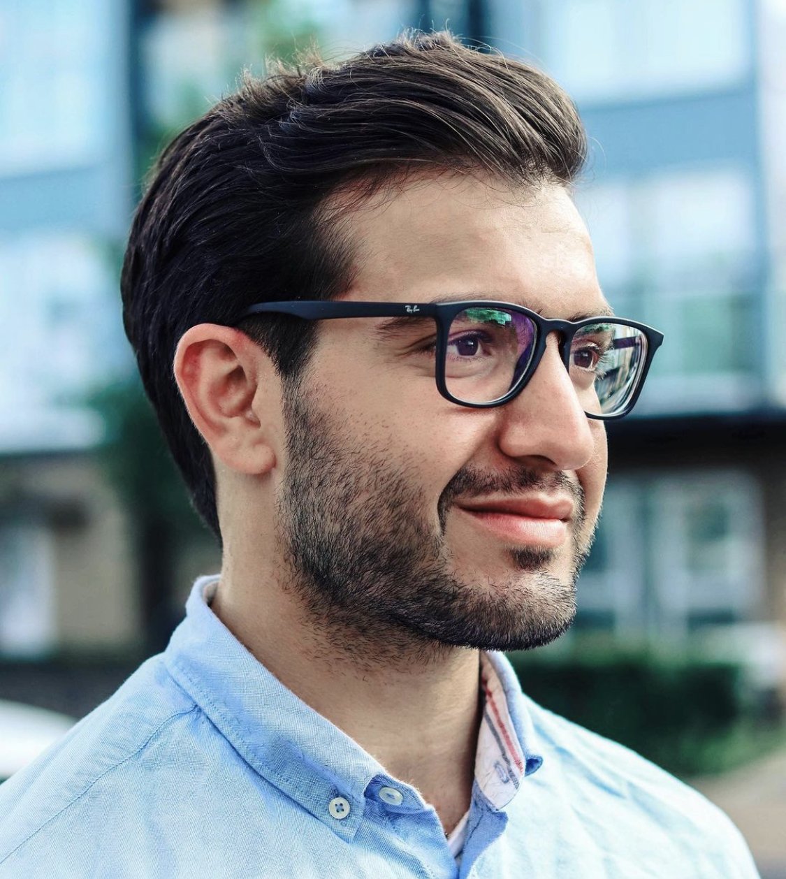 man with a slicked back haircut wearing glasses.jpeg